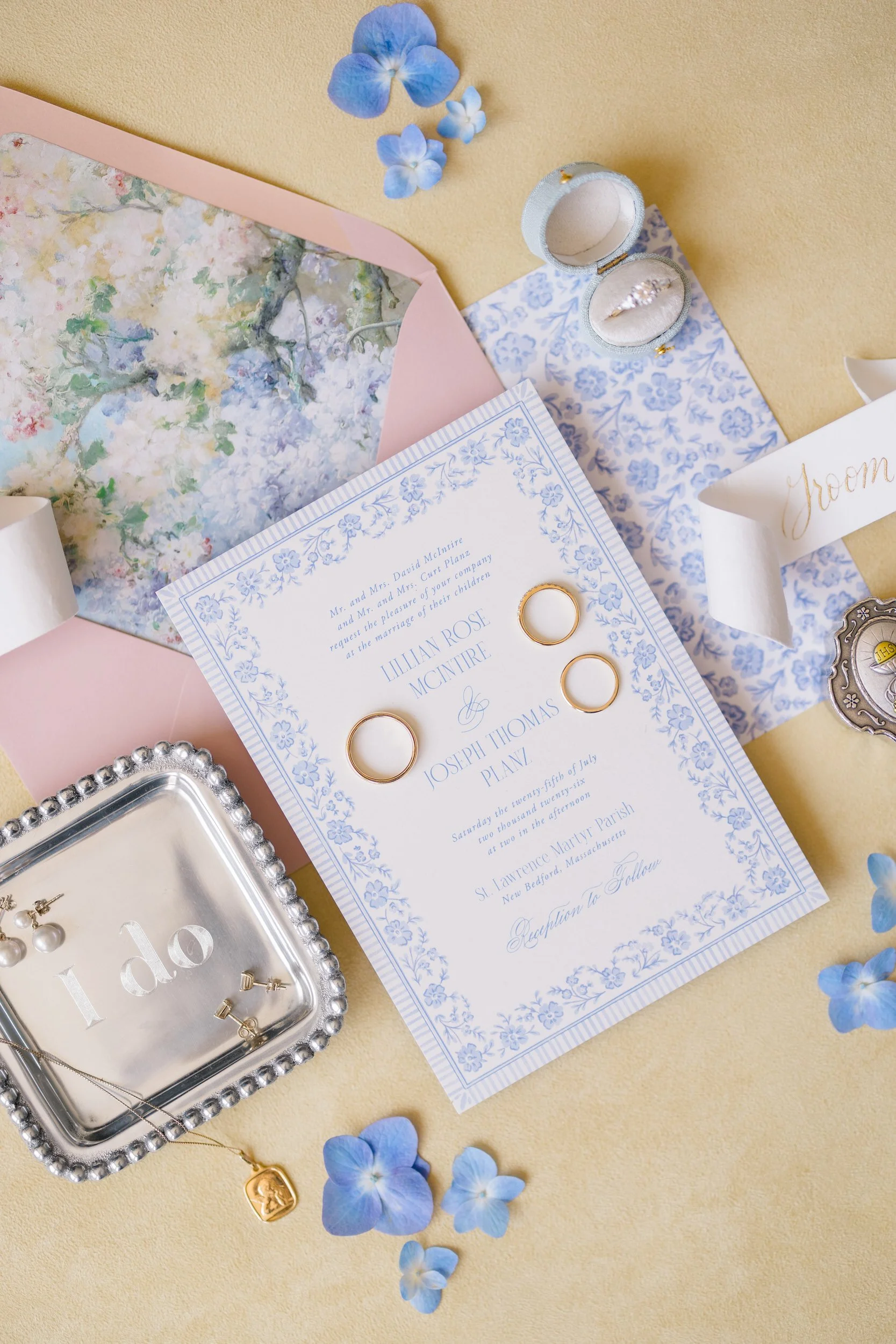 Elegant wedding flat lay with stationery, jewelry, and heirloom details for a coastal Cape Cod wedding.