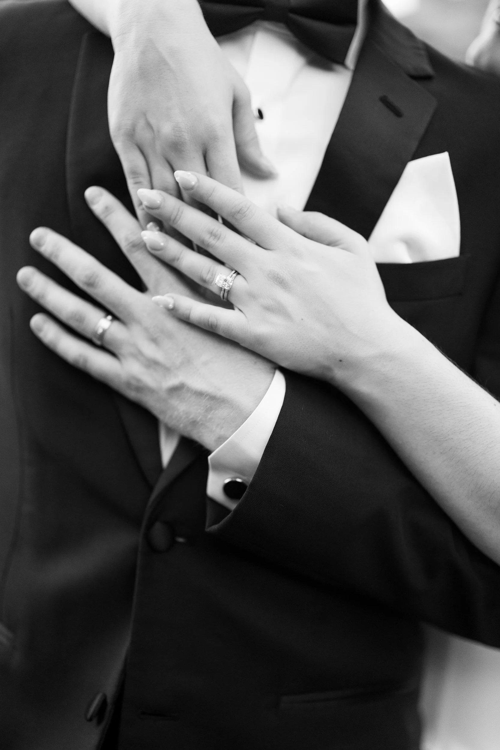 Bride and groom hold hands with wedding rings at Willowdale Estate wedding