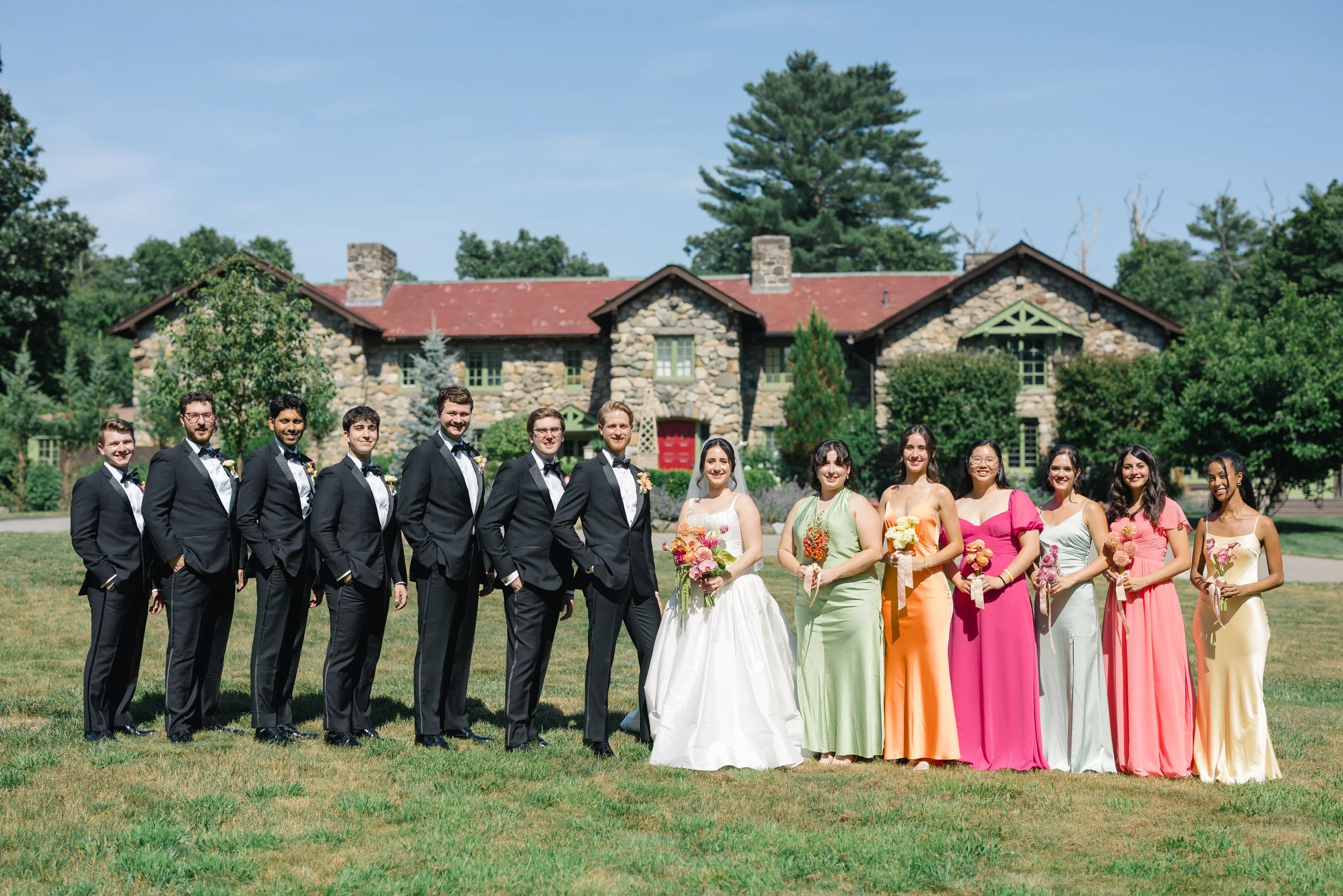 Large wedding party at Willowdale Estate celebrating colorful summer wedding in Massachusetts