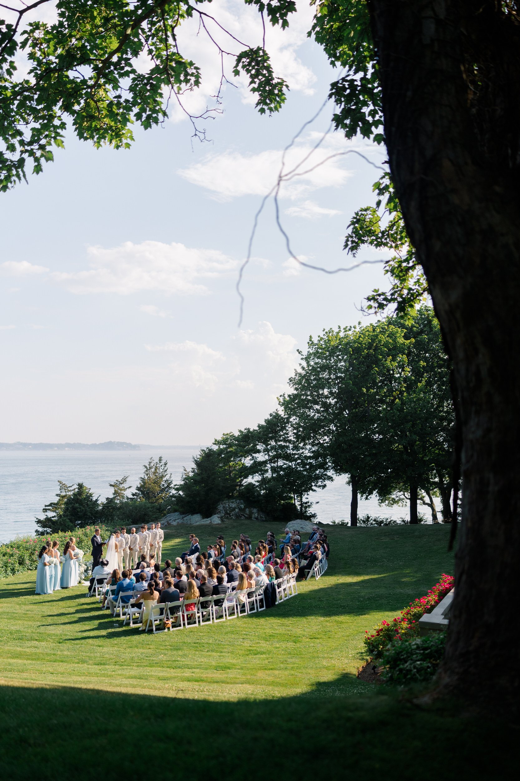 Summer wedding ceremony overlooking the ocean in Beverly, Massachusetts.