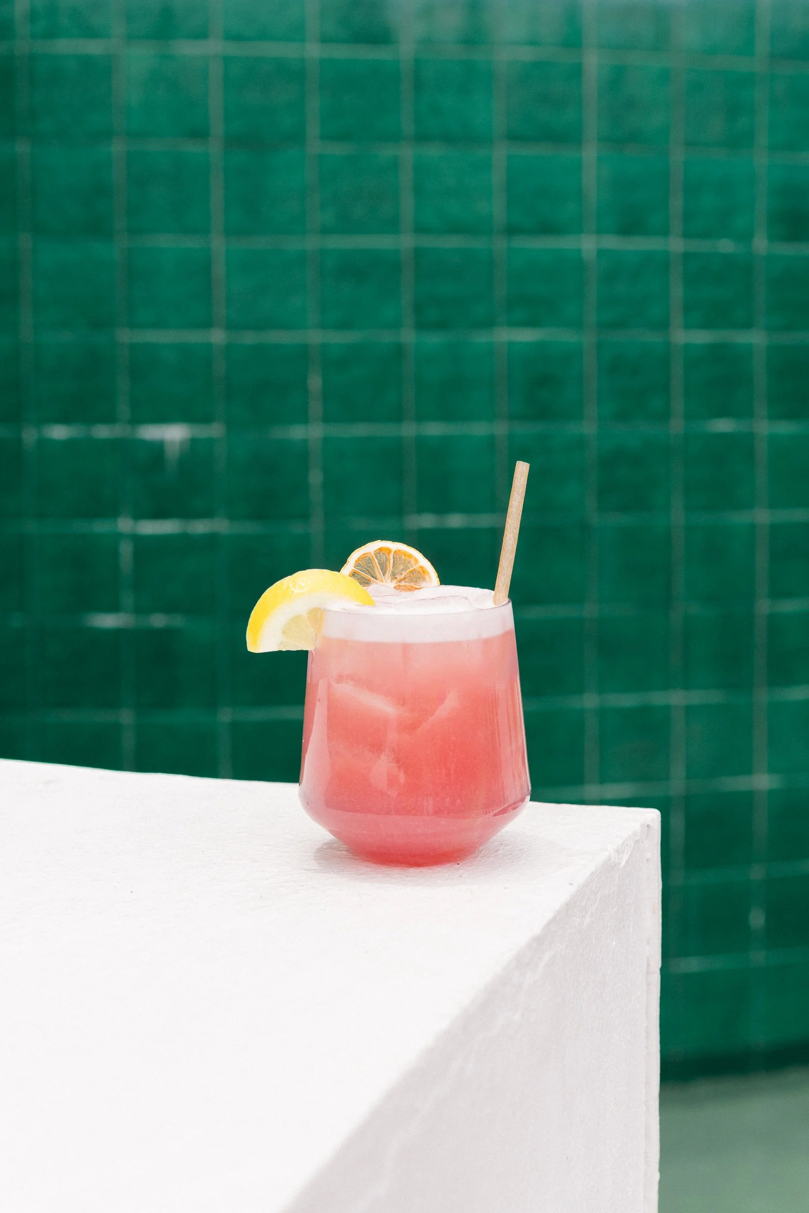 Pink cocktail against blue tile at The Pink Palm Hotel in St. Thomas