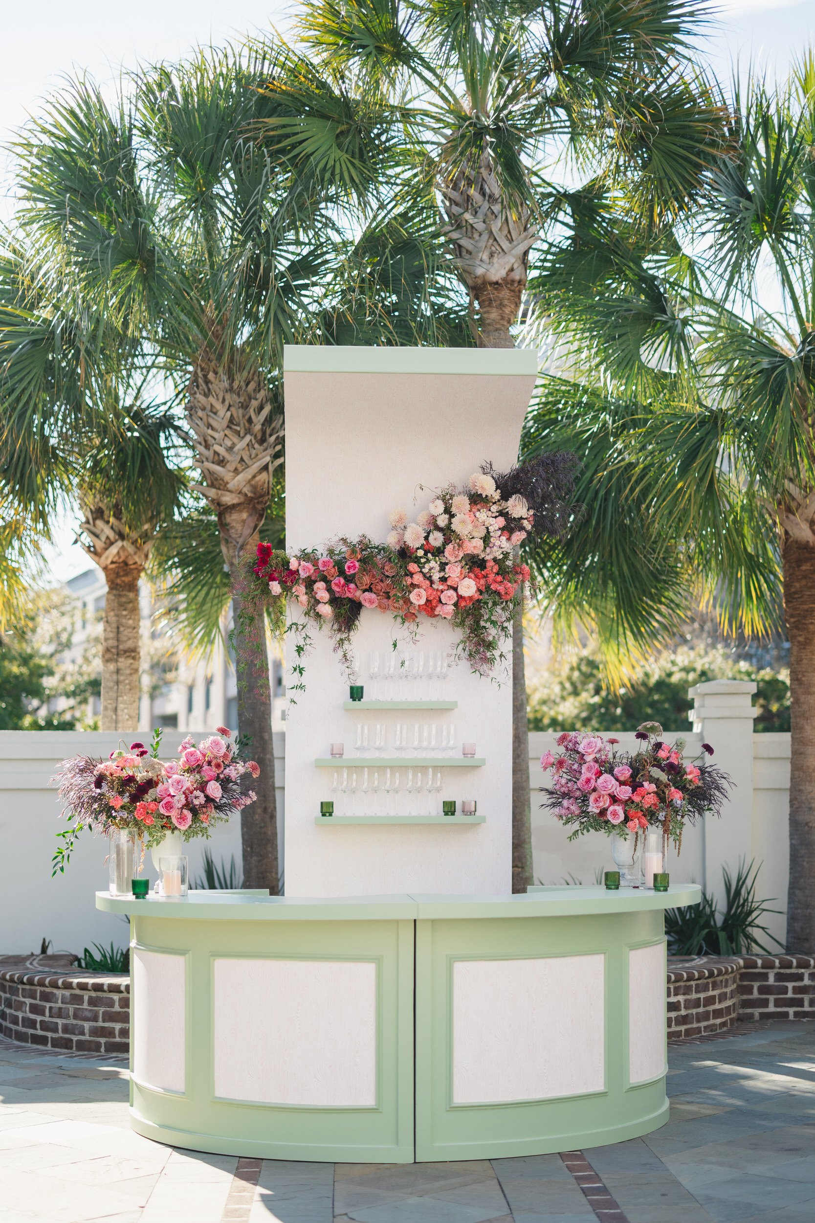 Custom green bar setup surrounded by stylish guests at The Gadsen House wedding reception.