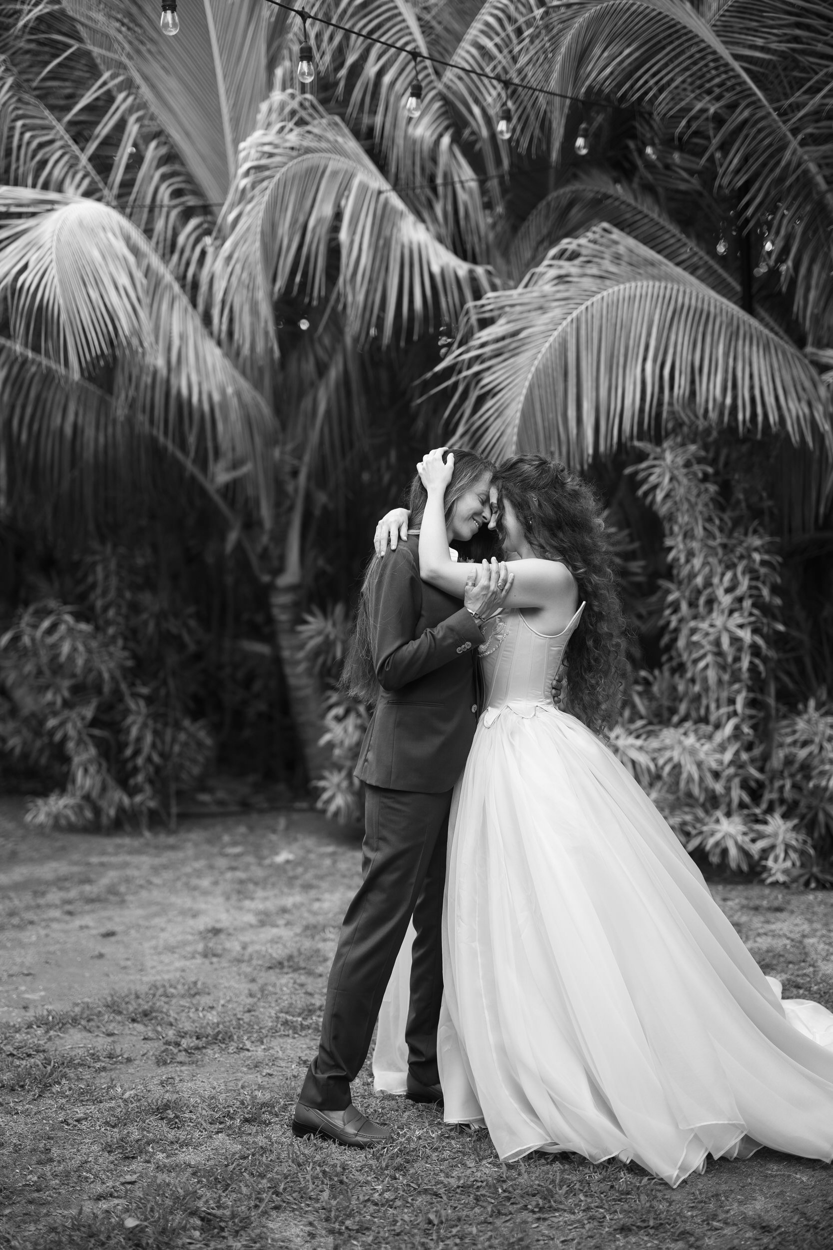 Two brides posing together at The Hideaway at Hull Bay wedding venue.