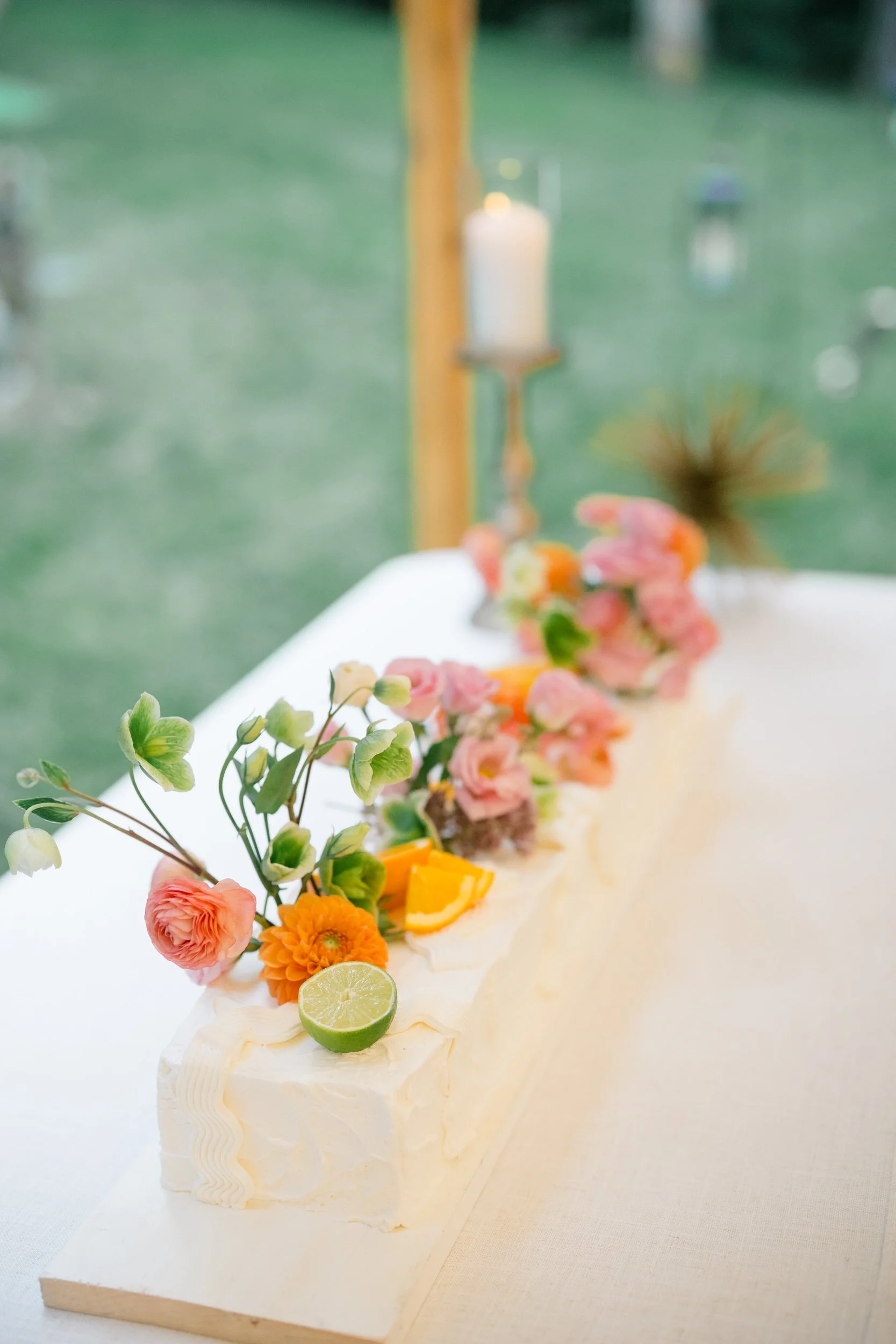 Colorful rectangular wedding cake decorated with playful swoops of frosting at the Connors Center.