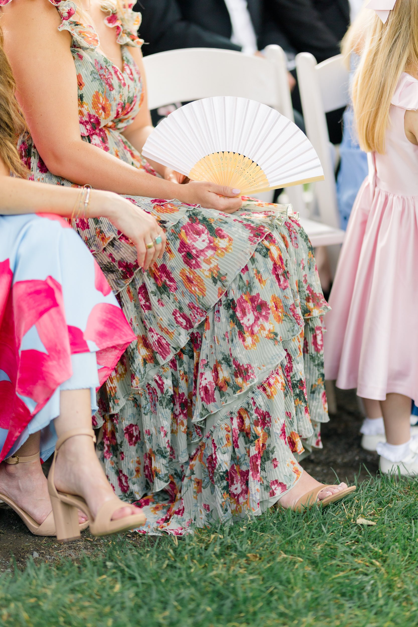 Guests watching a wedding ceremony surrounded by gardens