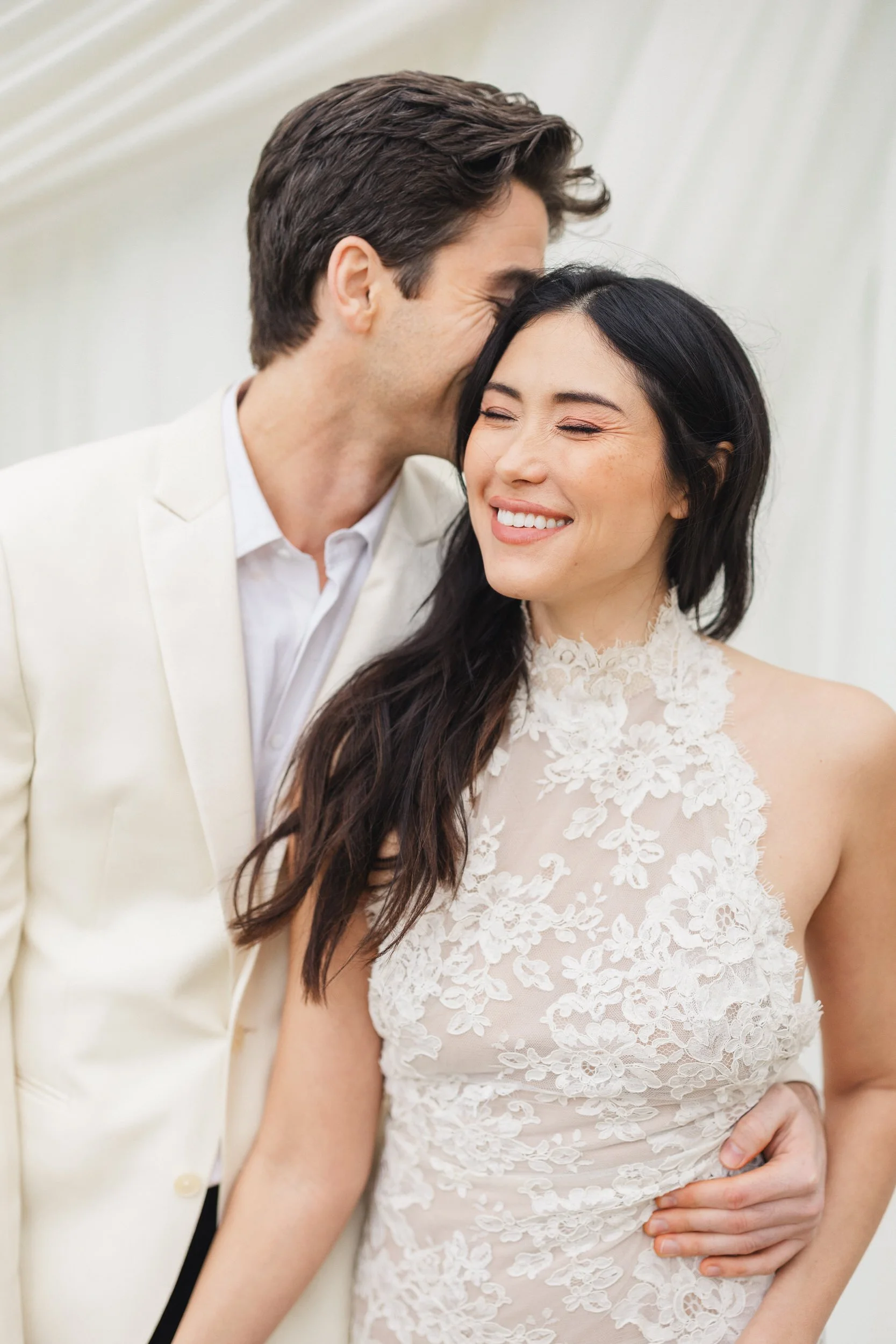 Elegant wedding portraits with white fabric ceremony backdrop at Lowndes Grove