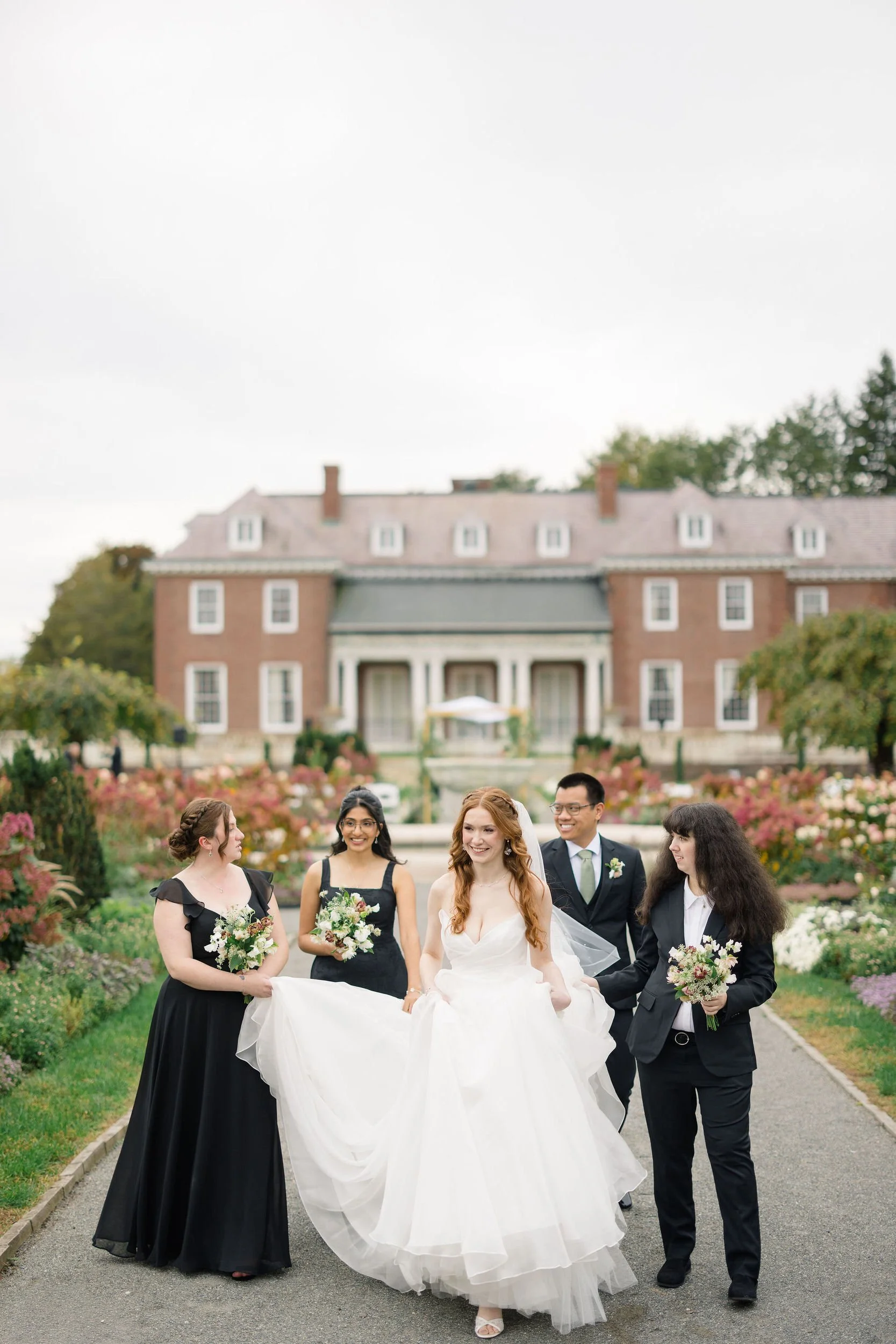 Bridesmaids portraits at a fall secret garden wedding surrounded by seasonal garden scenery.