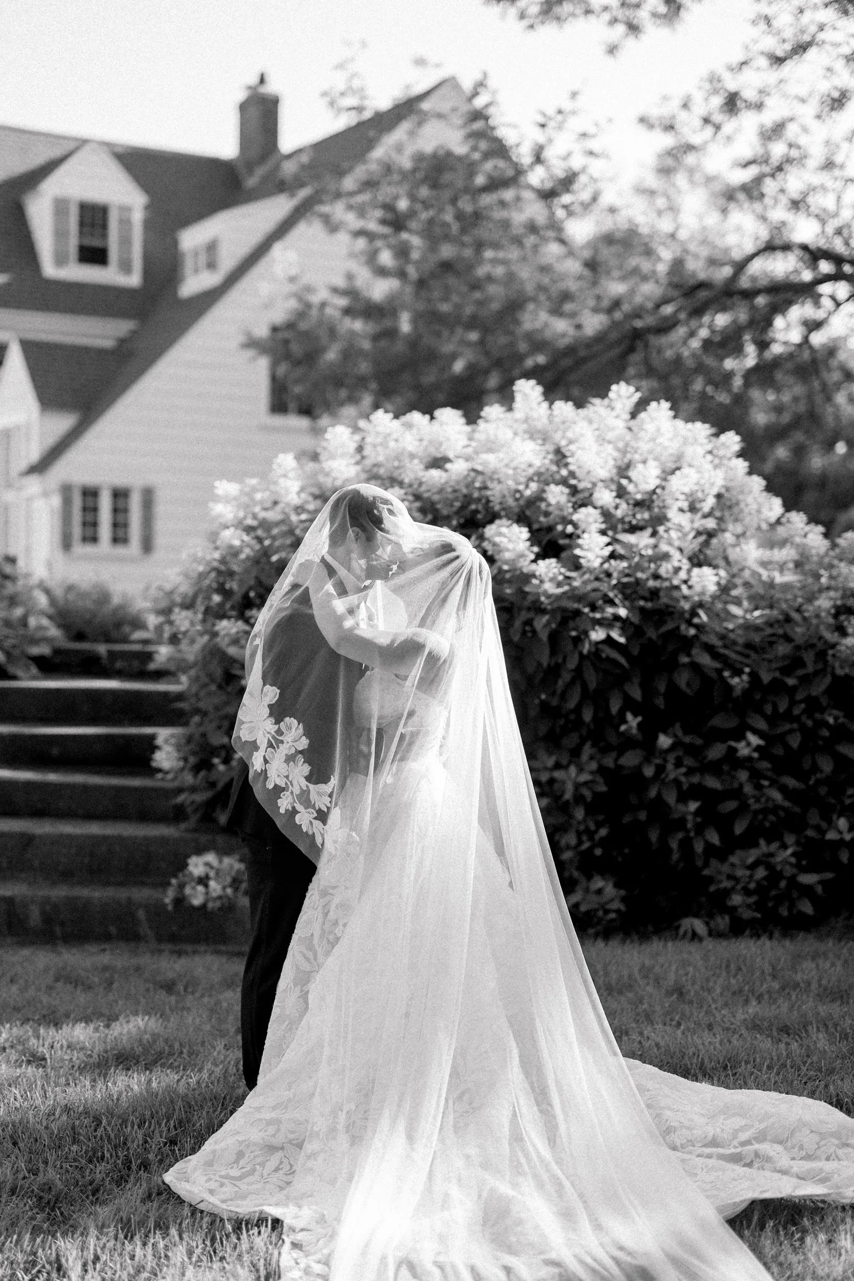 Romantic newlywed portraits surrounded by hydrangeas during a luxury Cape Cod private estate wedding.