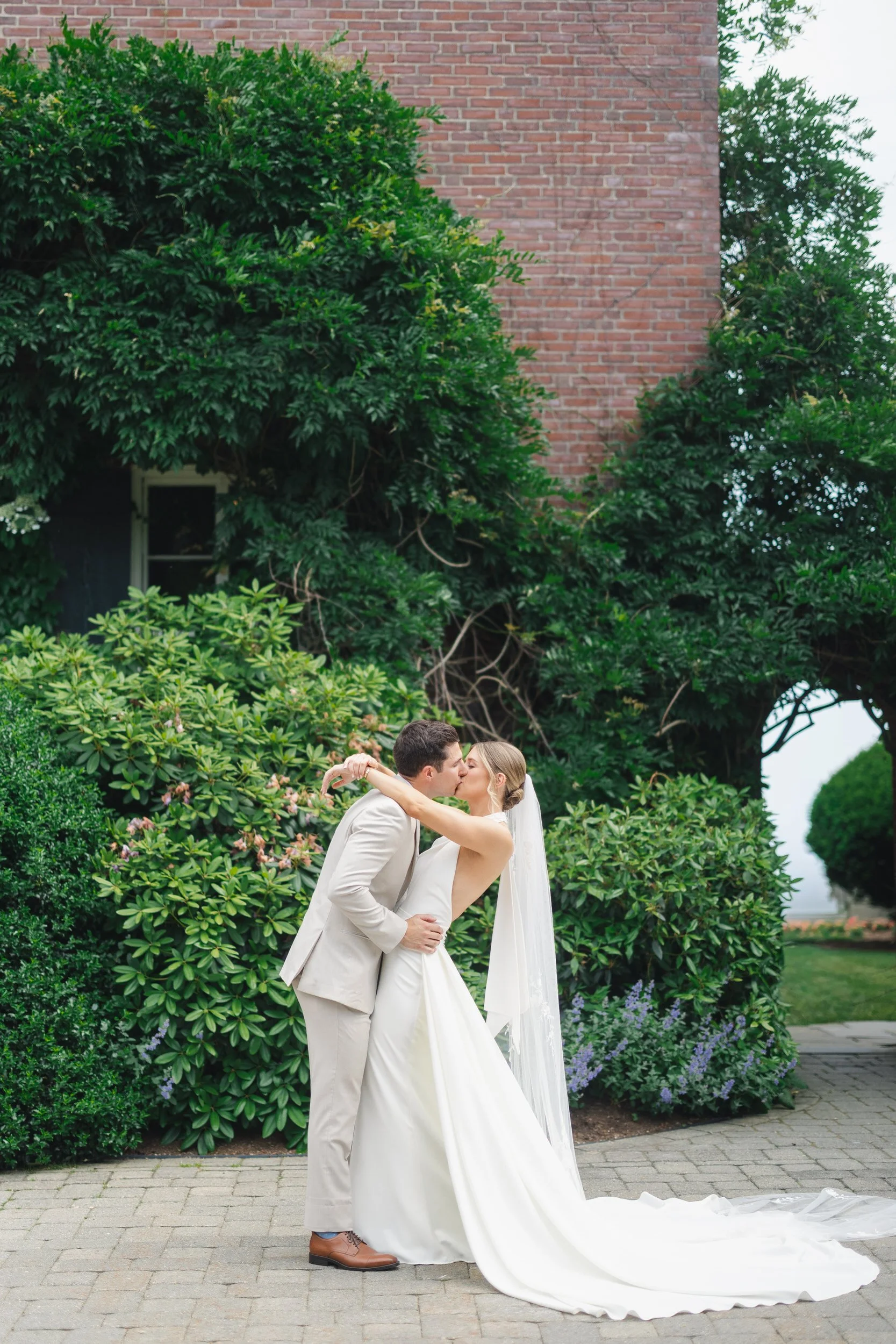 Elegant couple portraits at a coastal garden party wedding.