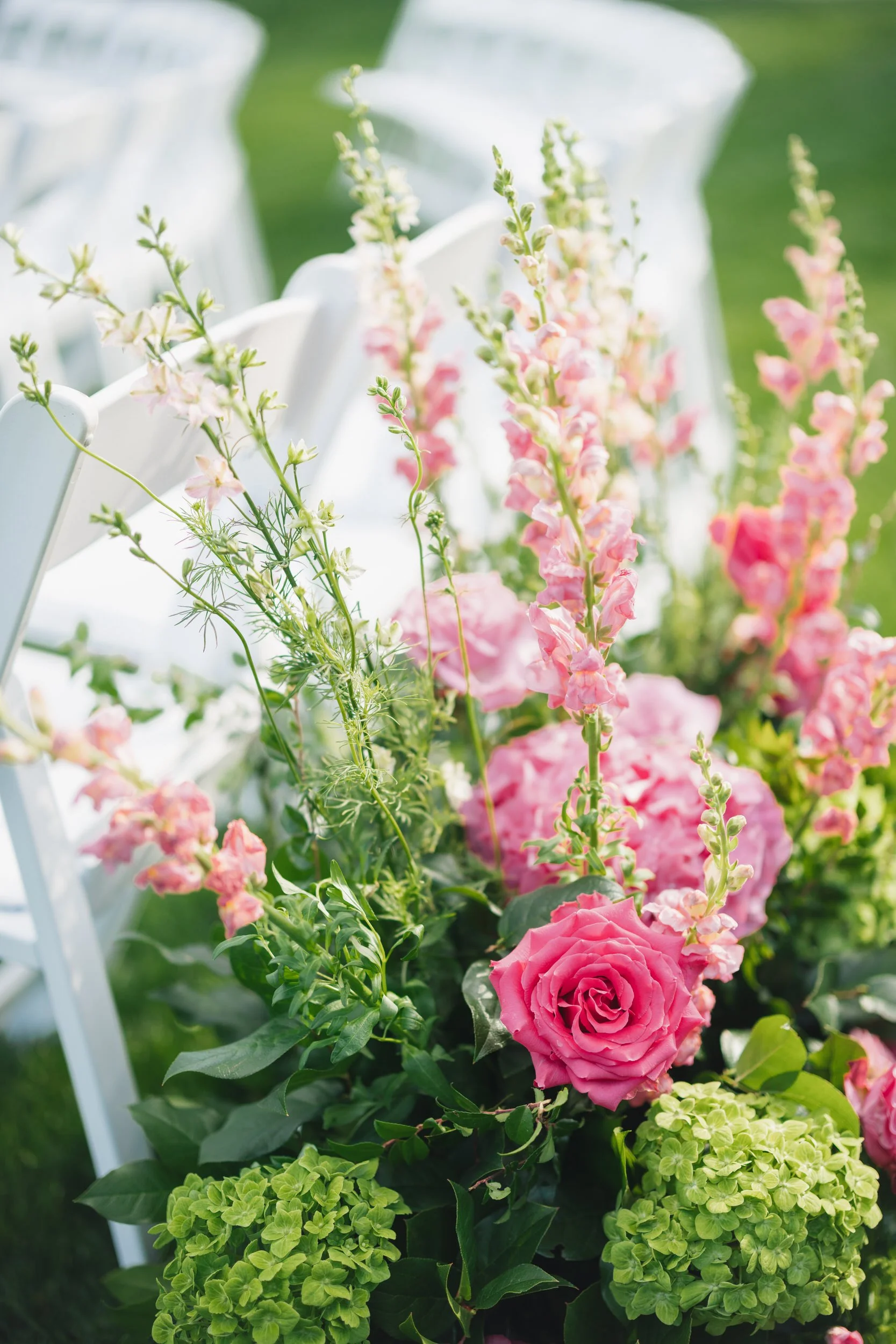 Modern wedding ceremony design with mauve, pink, and green flowers