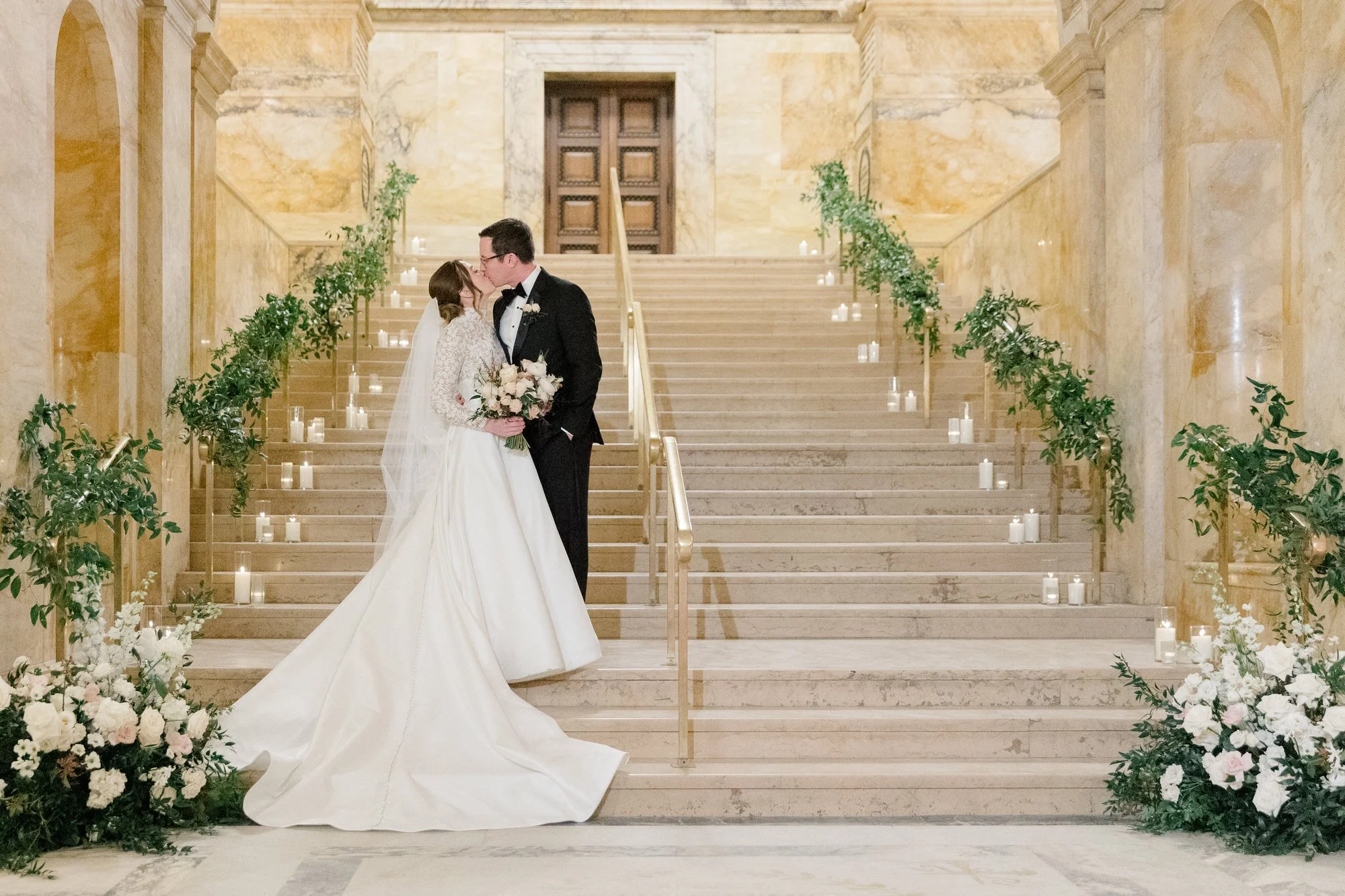 Couple's portraits on the stairs with florals at Boston Public Library Wedding