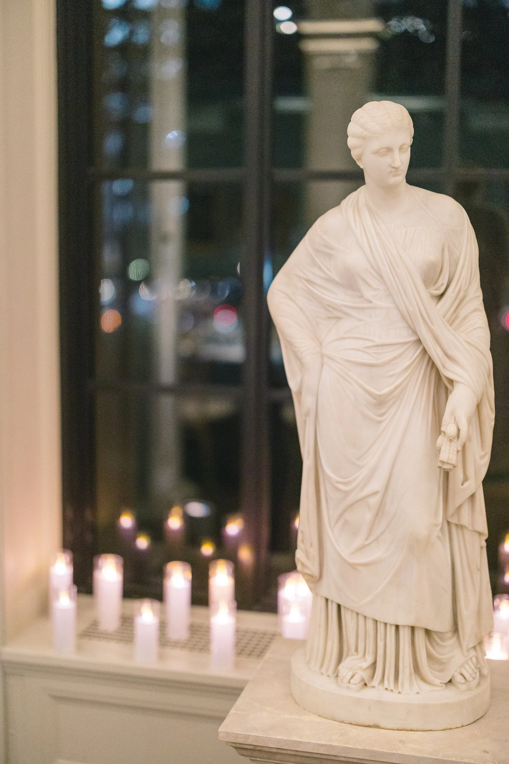 Candid moment during a Boston Athenaeum rehearsal dinner surrounded by historic bookshelves