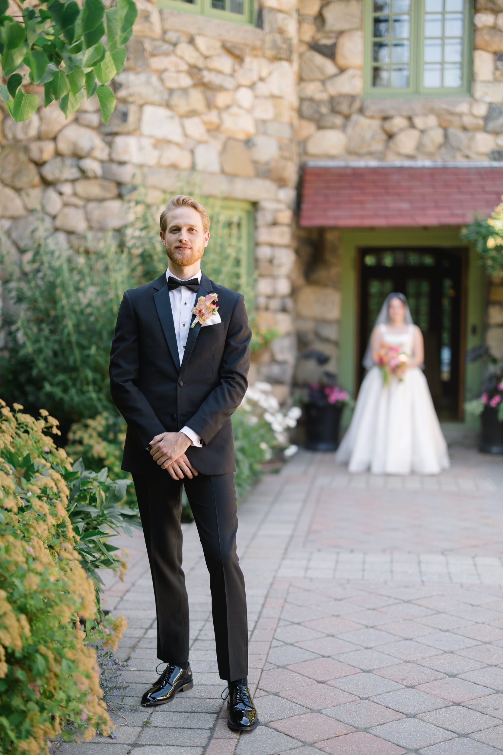 Emotional first look between bride and groom at Willowdale Estate courtyard in Topsfield Massachusetts