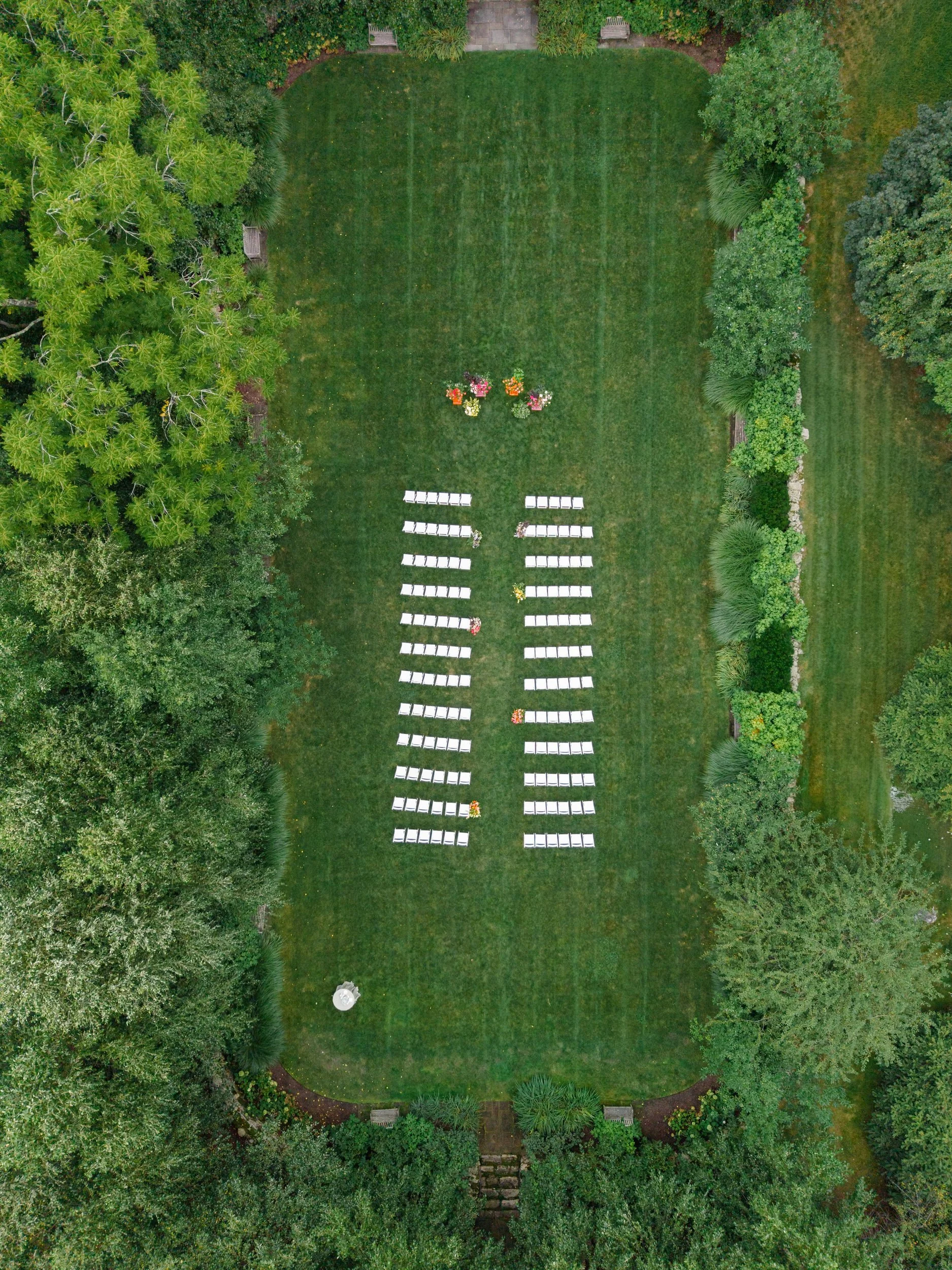 Colorful secret garden ceremony at the Connors Center featuring vibrant seasonal flowers.