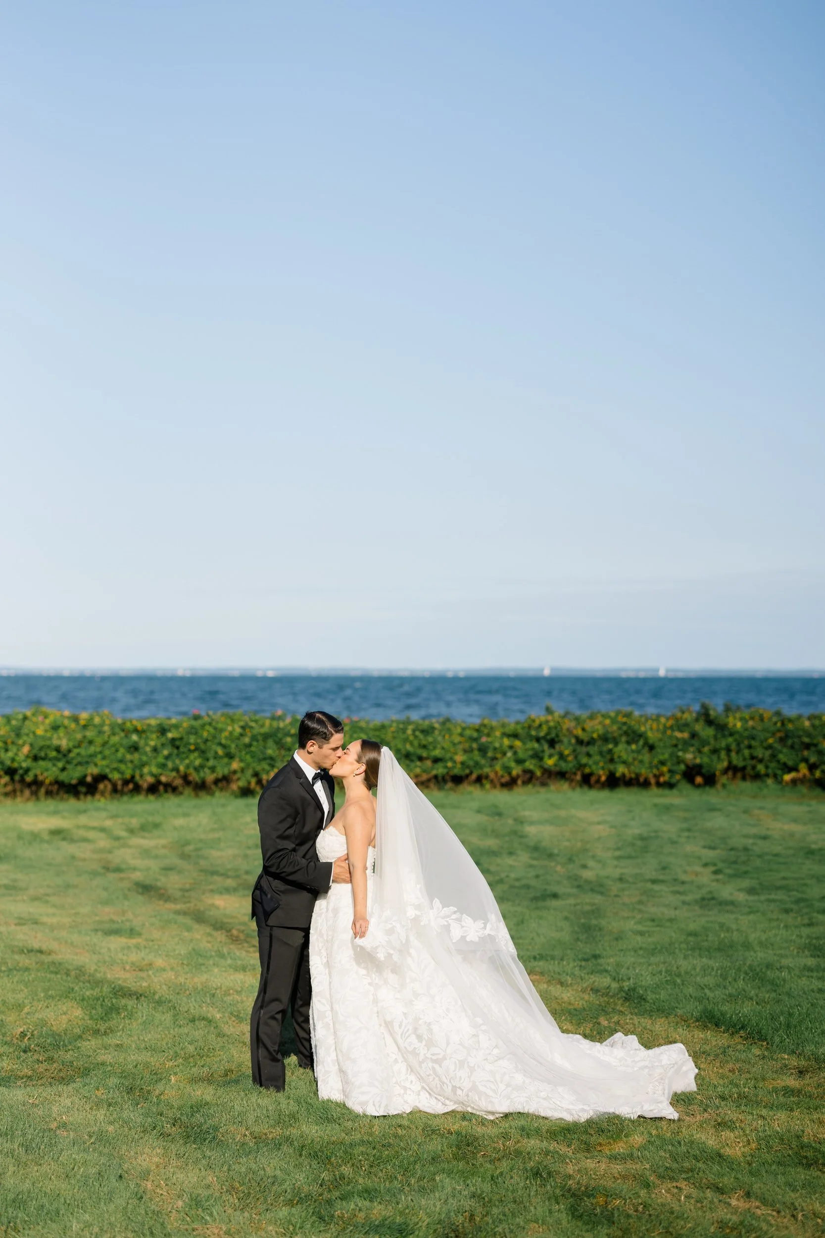 Bride and groom together outside a Cape Cod private estate overlooking the water.