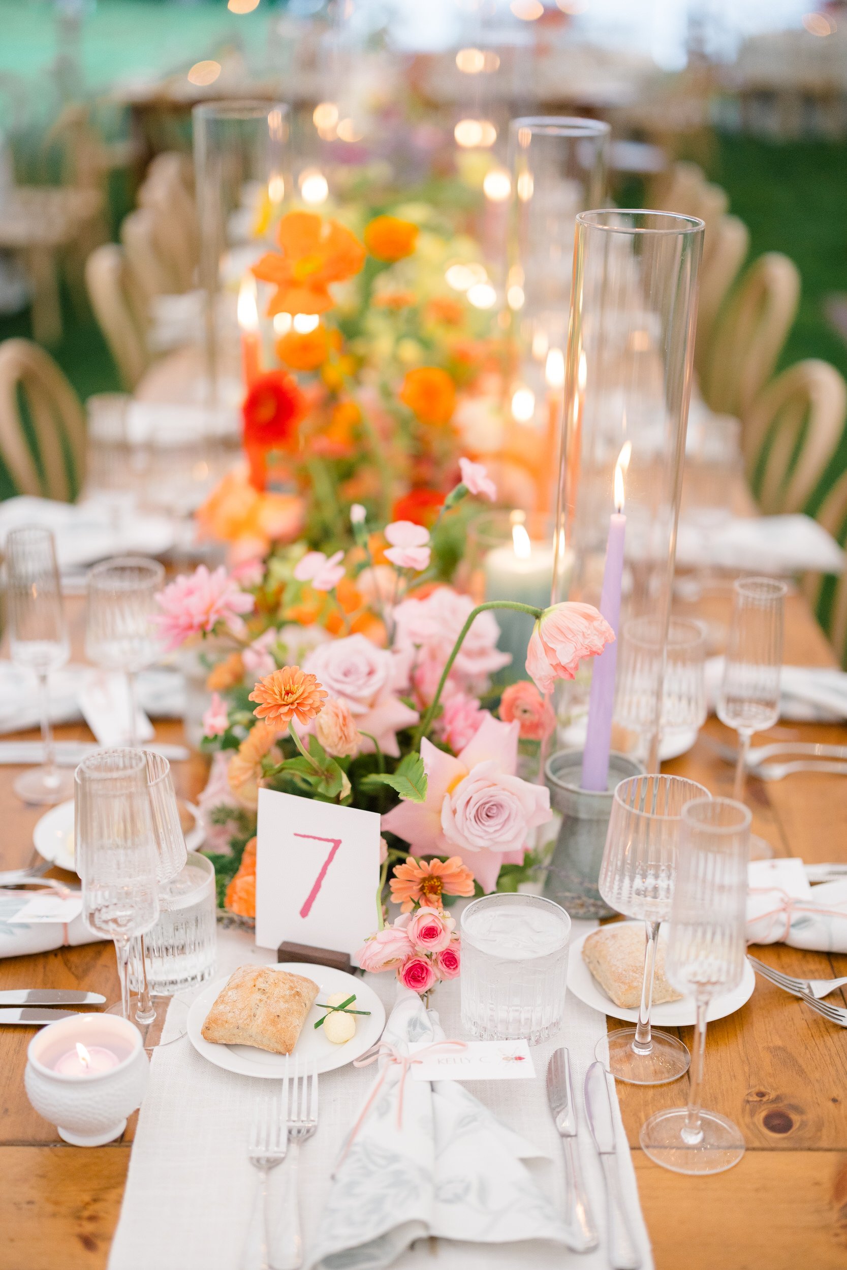 Reception tent transformed into a colorful secret garden with lush seasonal flowers.
