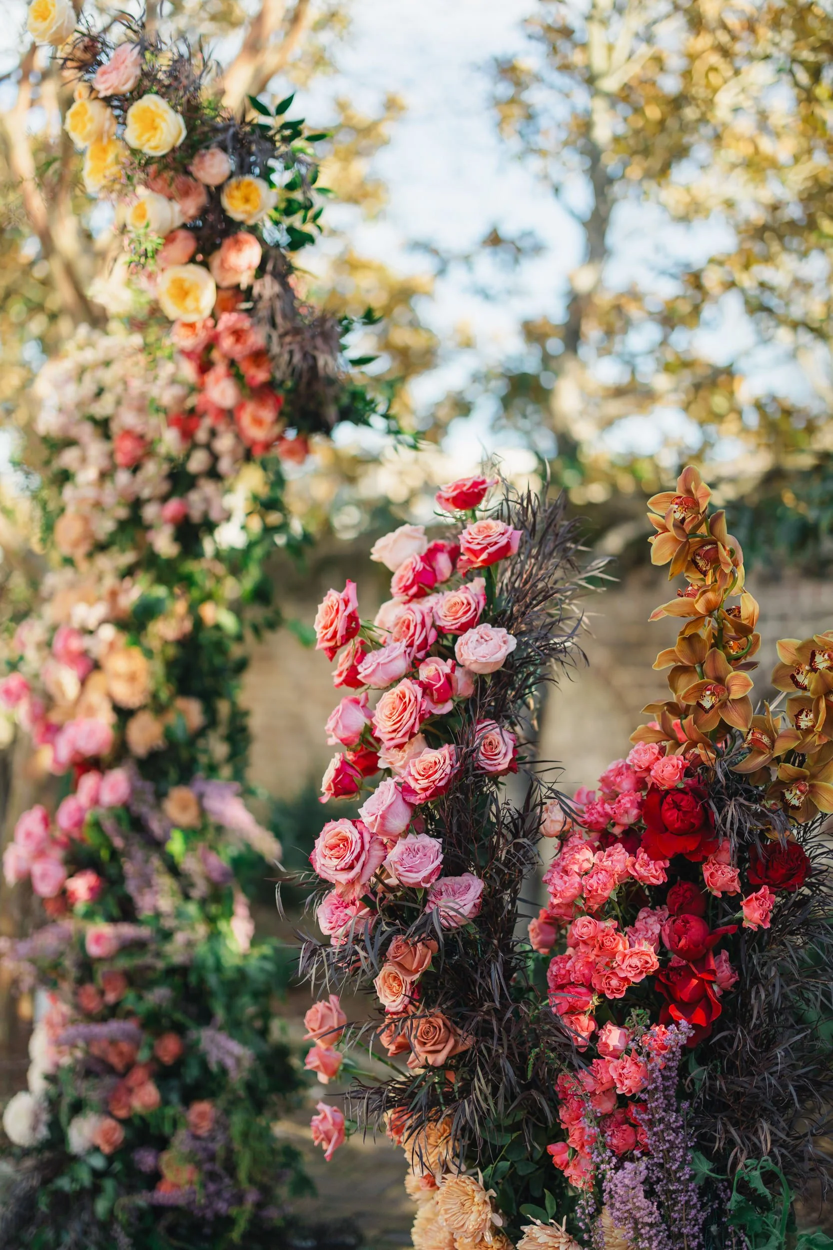 Romantic ceremony backdrop featuring cascading pink flowers at The Gadsen House.