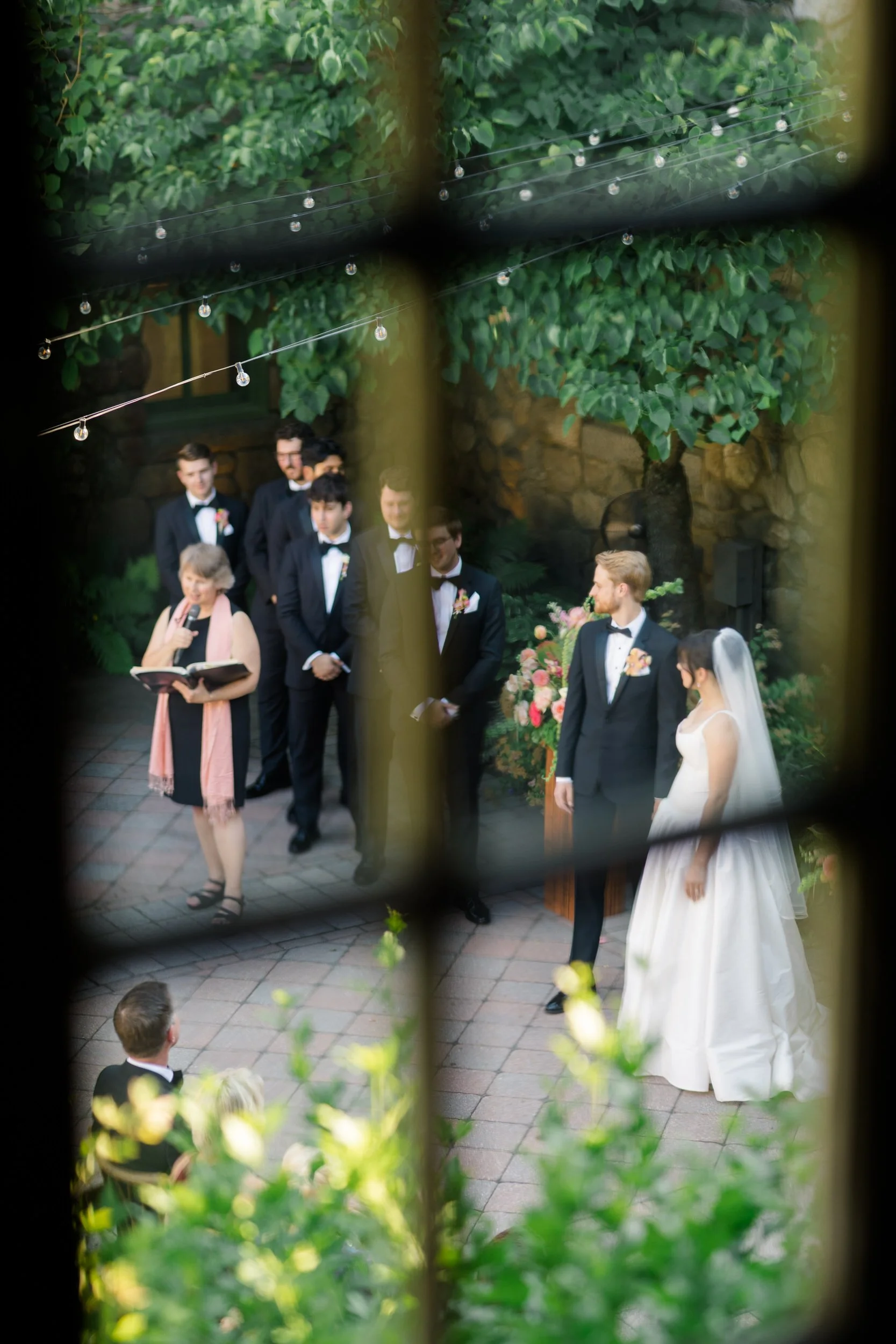 Couple during outdoor ceremony at Willowdale Estate surrounded by vibrant floral design