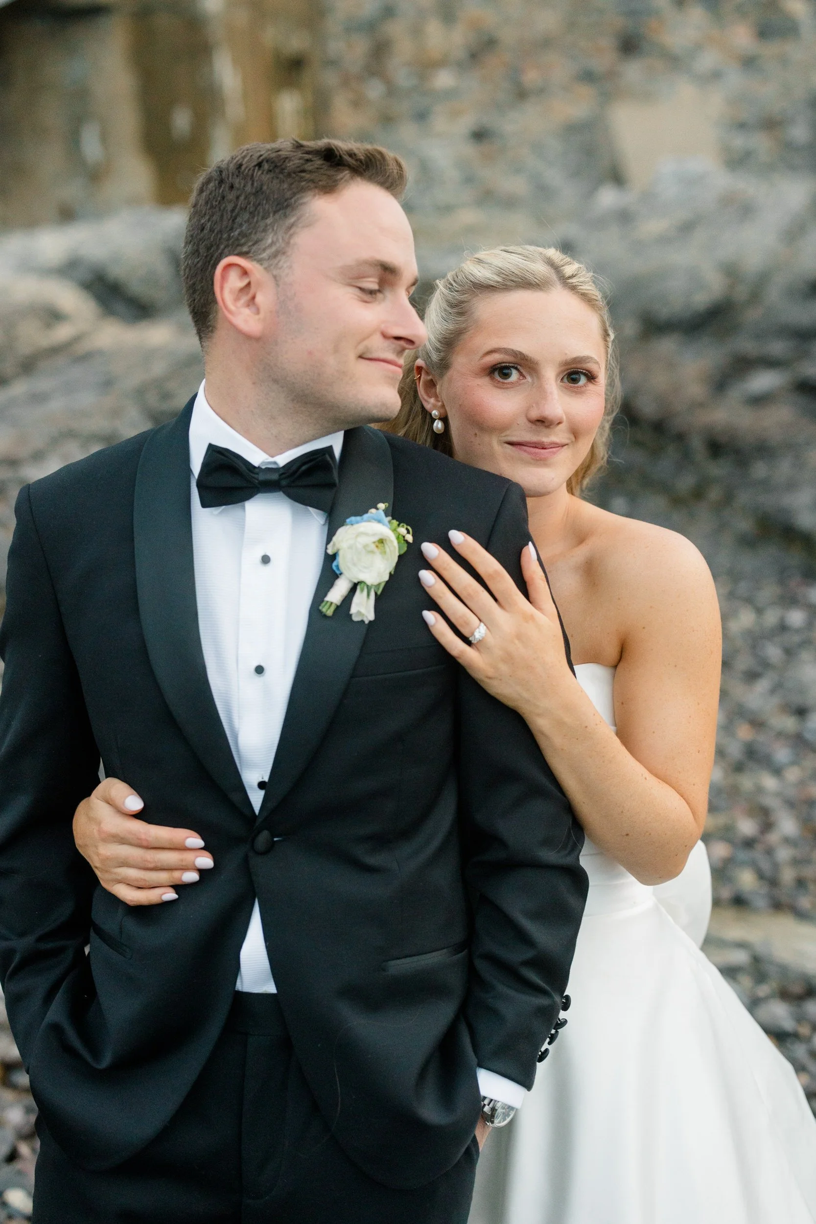 Bride and groom sunset portraits at Corinthian Yacht Club with sail-filled harbor views.
