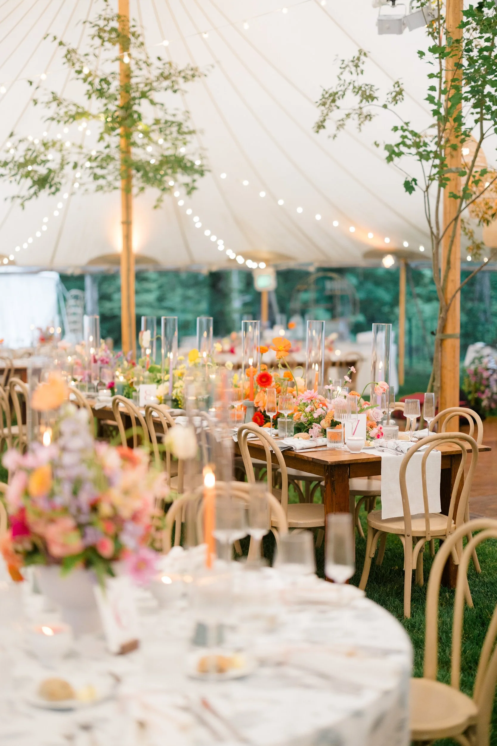 Vibrant reception tablescape surrounded by lush dahlias, English roses, and poppies.