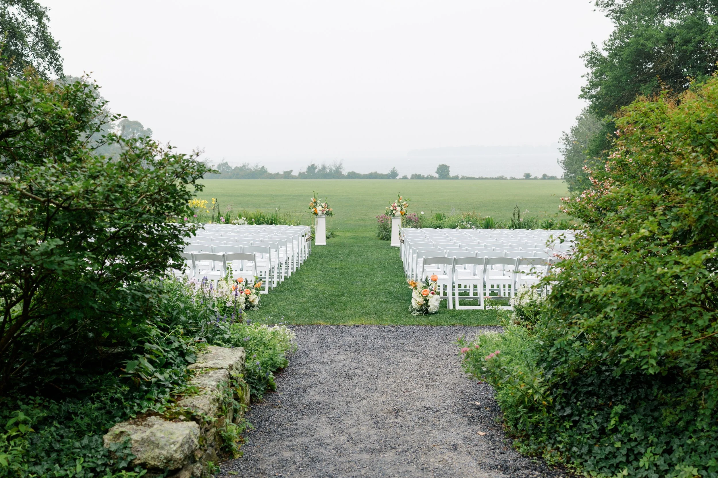 Outdoor garden ceremony decorated with vibrant wildflower-inspired florals at Blithewold.