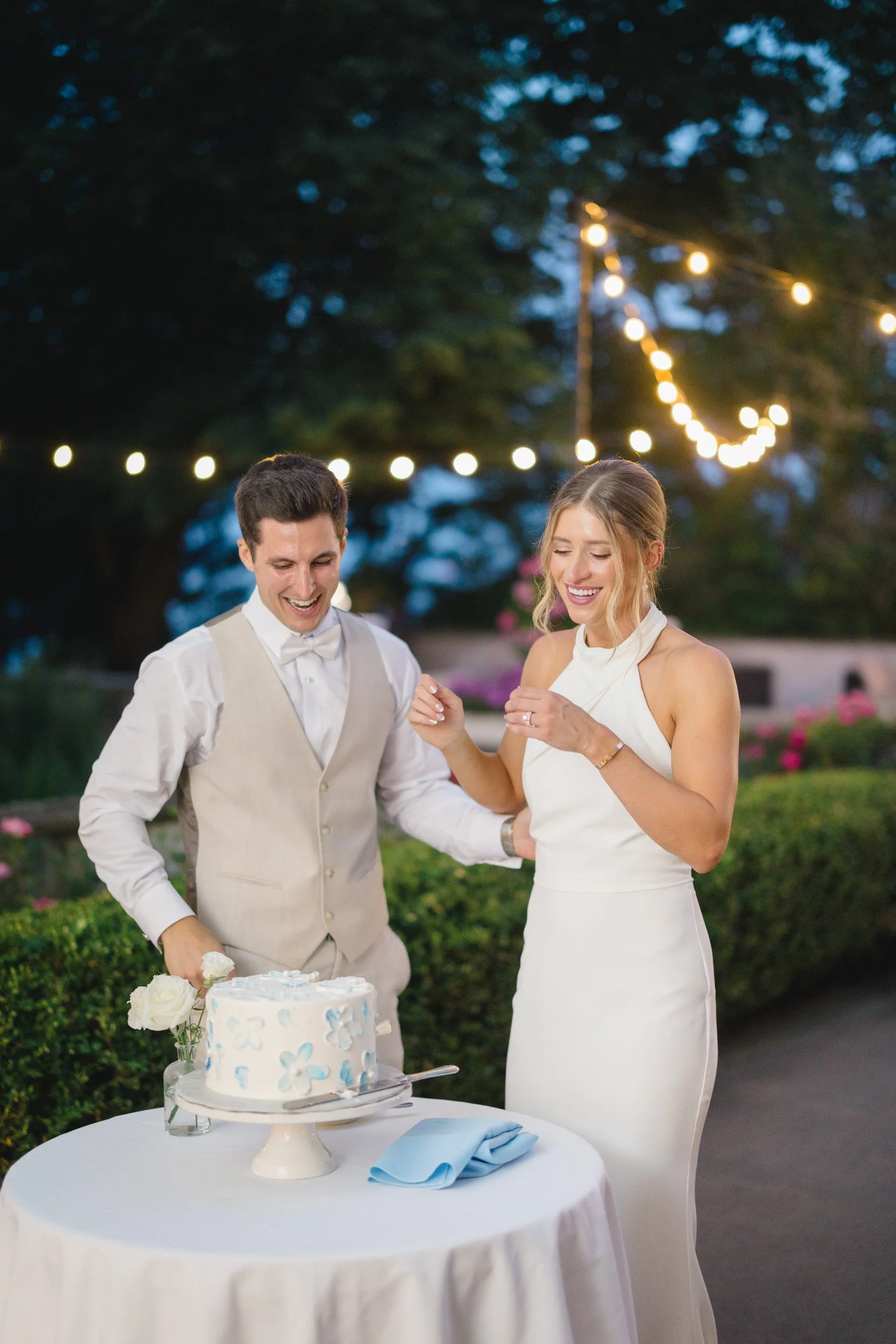Bride and groom cutting their wedding cake during the reception.
