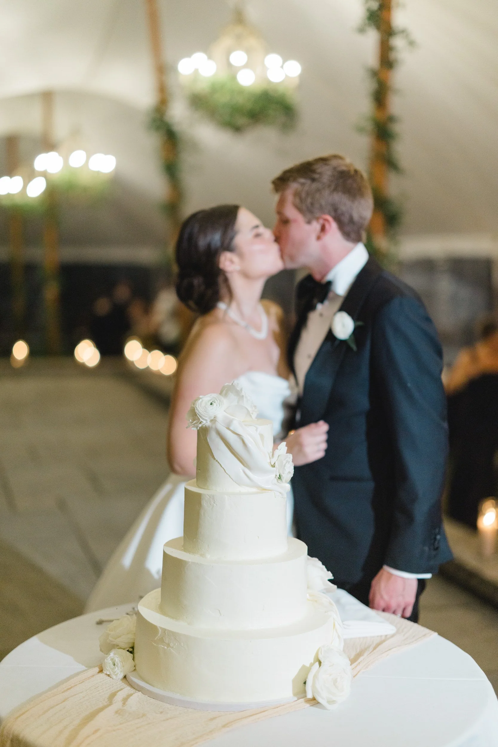 Bride and groom cutting their wedding cake during the reception at Castle Hill on the Crane Estate in Ipswich, Massachusetts.