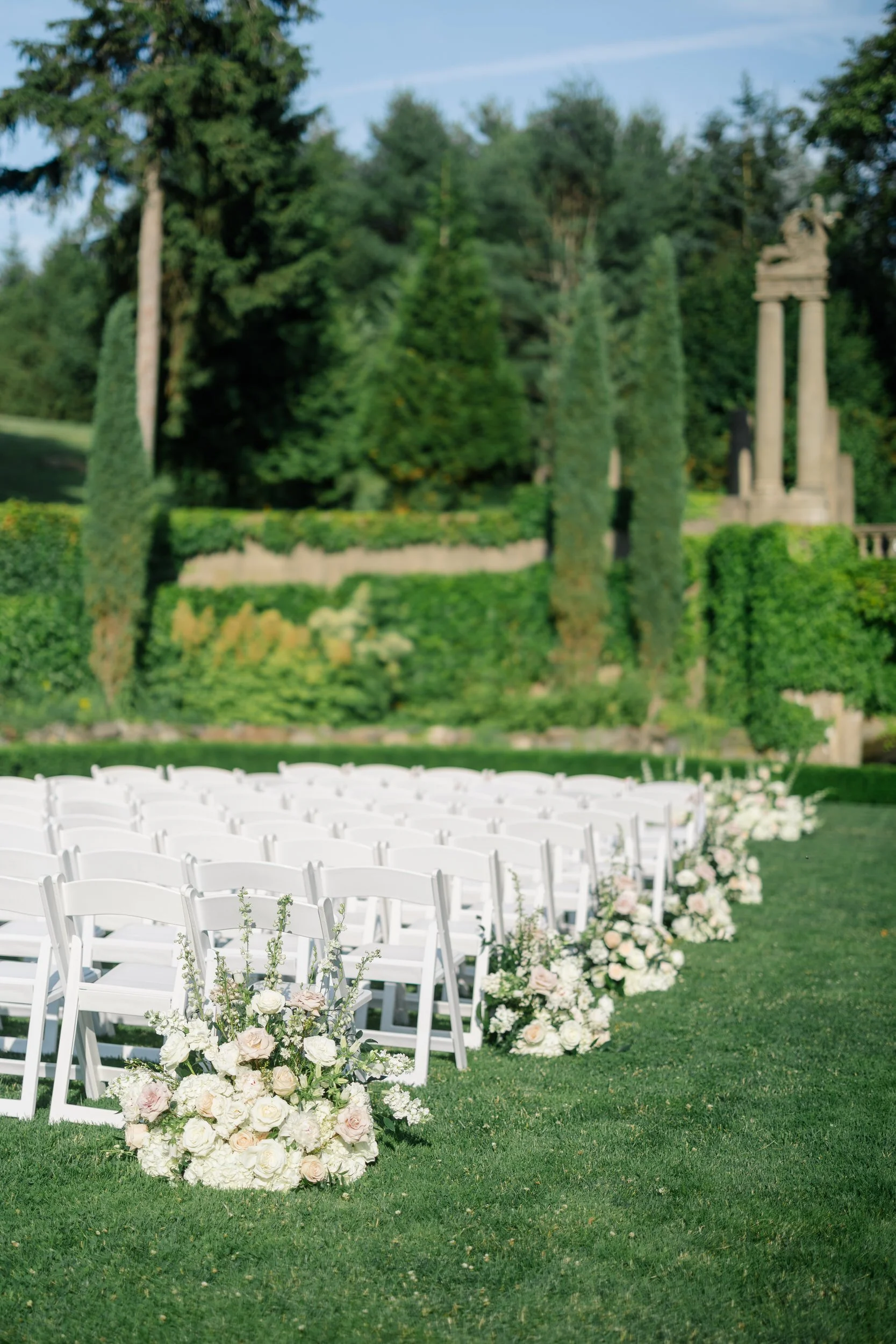 Beautifully styled wedding ceremony site in the Italian Garden at Castle Hill overlooking the formal estate gardens.