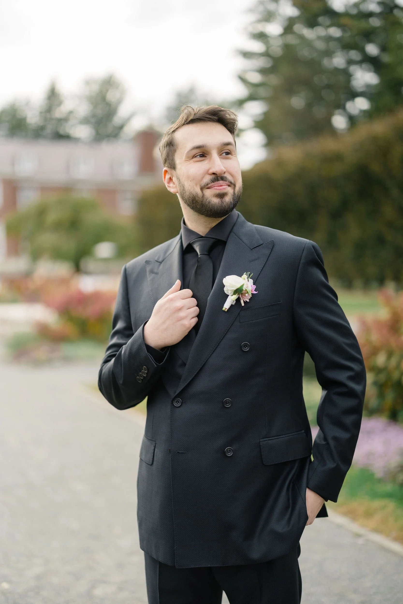 Groom portraits at a secret garden inspired wedding with an elegant, timeless aesthetic.