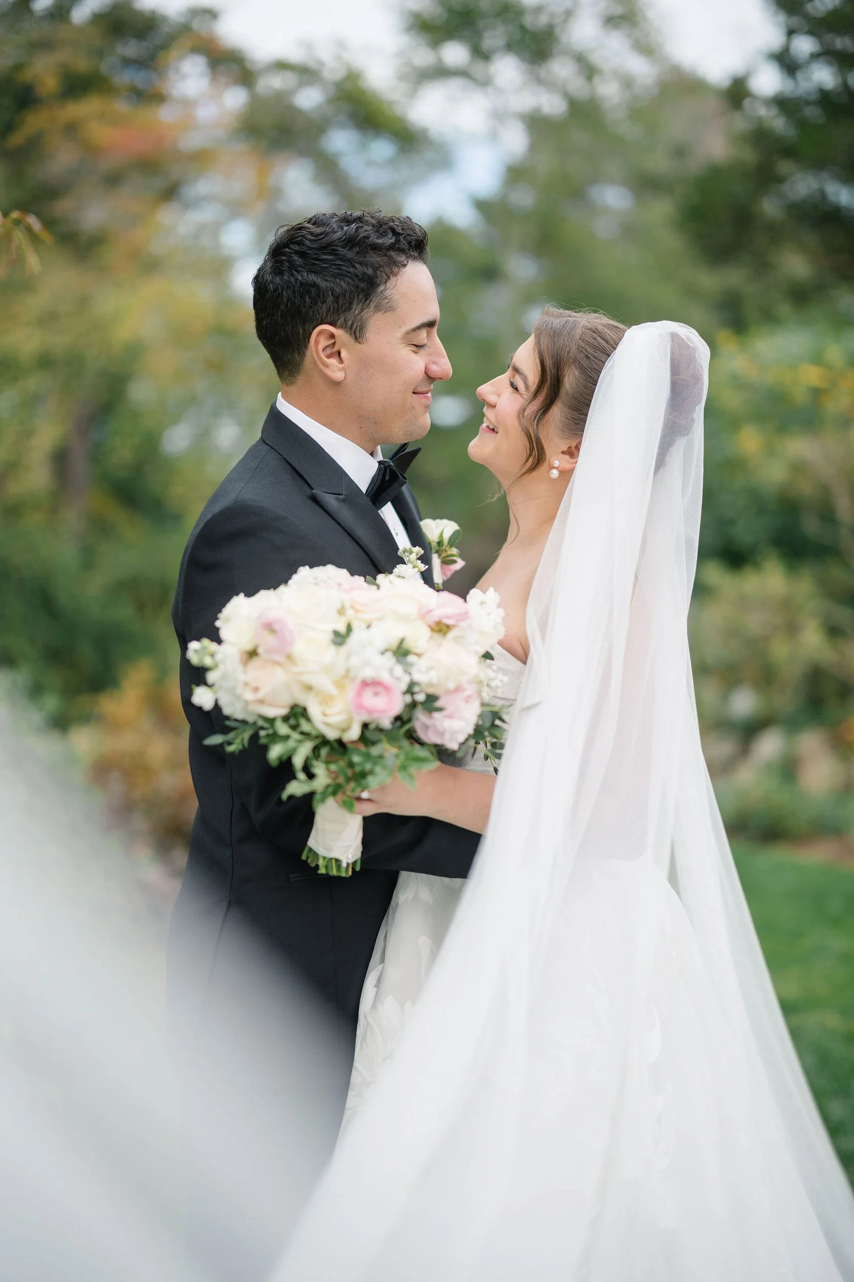 Newlyweds walking through the landscaped gardens during their Long Hill wedding.