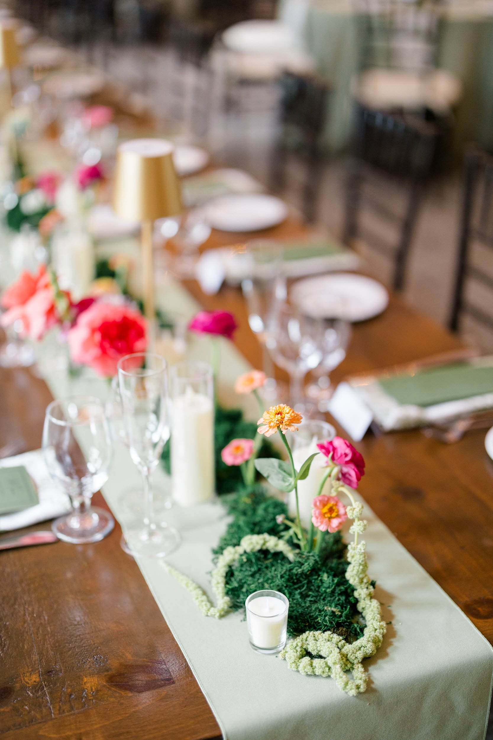 Moss-lined wedding tables with floral details at The Gardens at Elm Bank