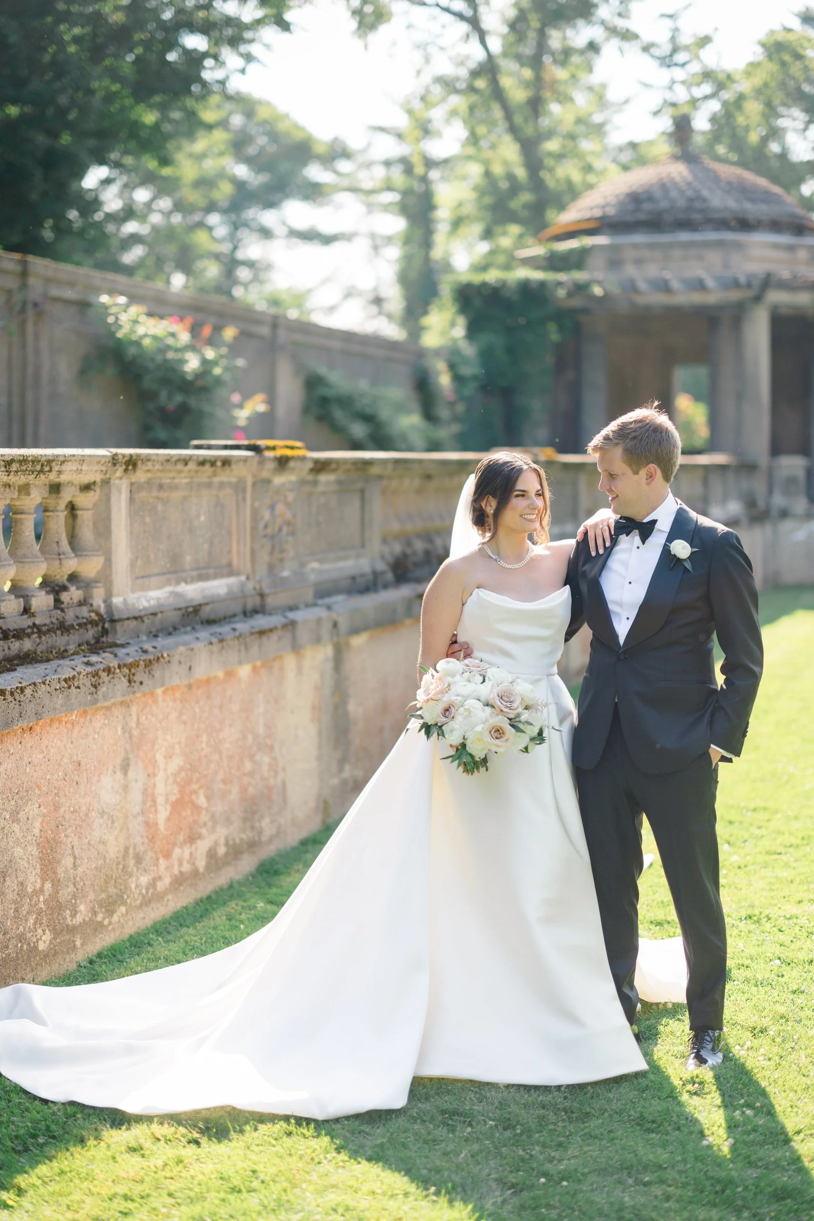 Candid couple’s portraits captured in soft natural light throughout the Crane Estate estate grounds.