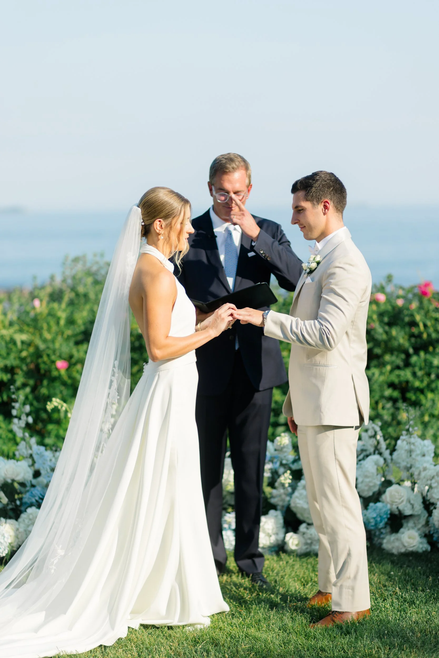 Emotional wedding ceremony surrounded by family, friends, and ocean views.