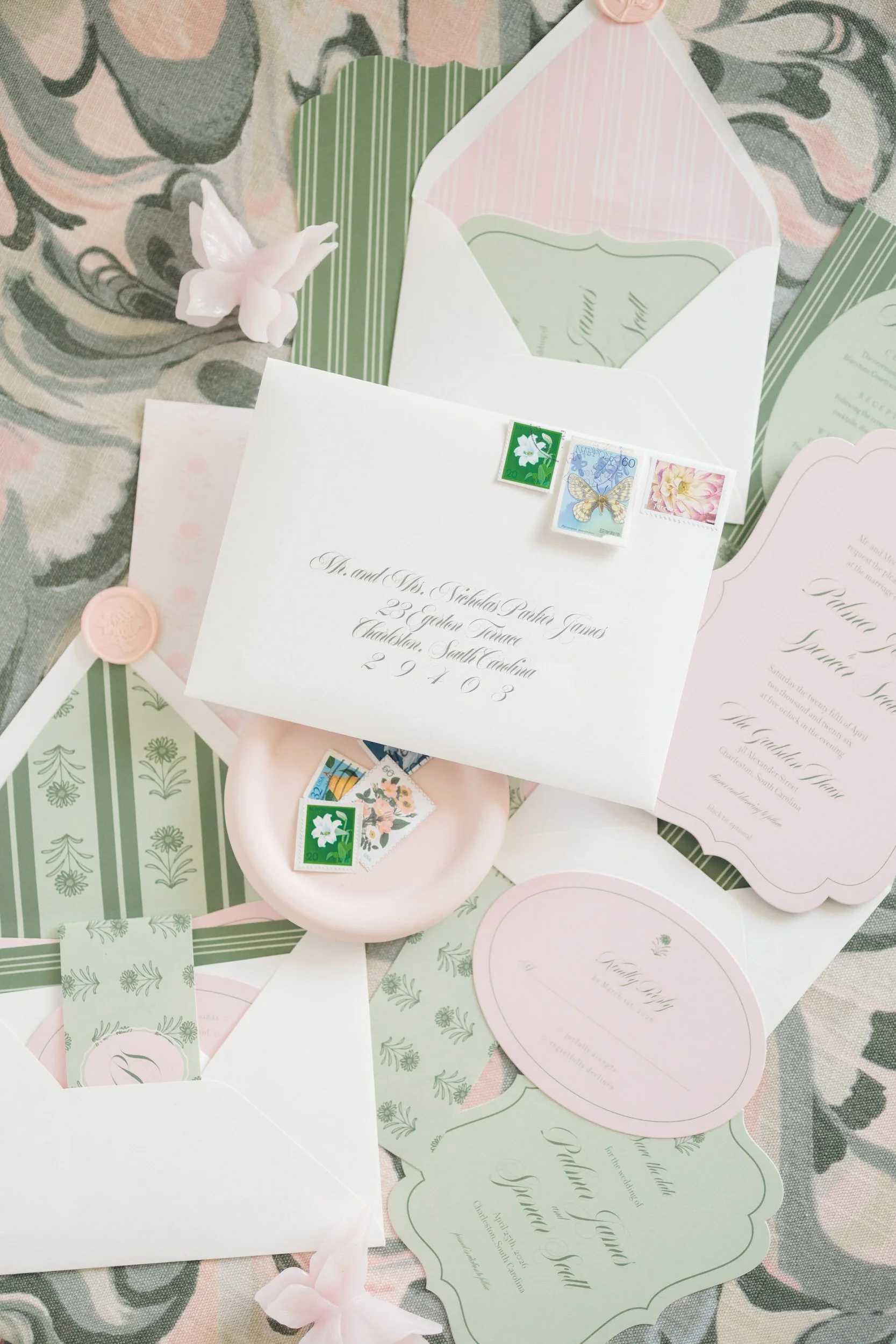 Colorful spring wedding flat lay with pink florals and invitation suite at The Gadsen House in Charleston, South Carolina
