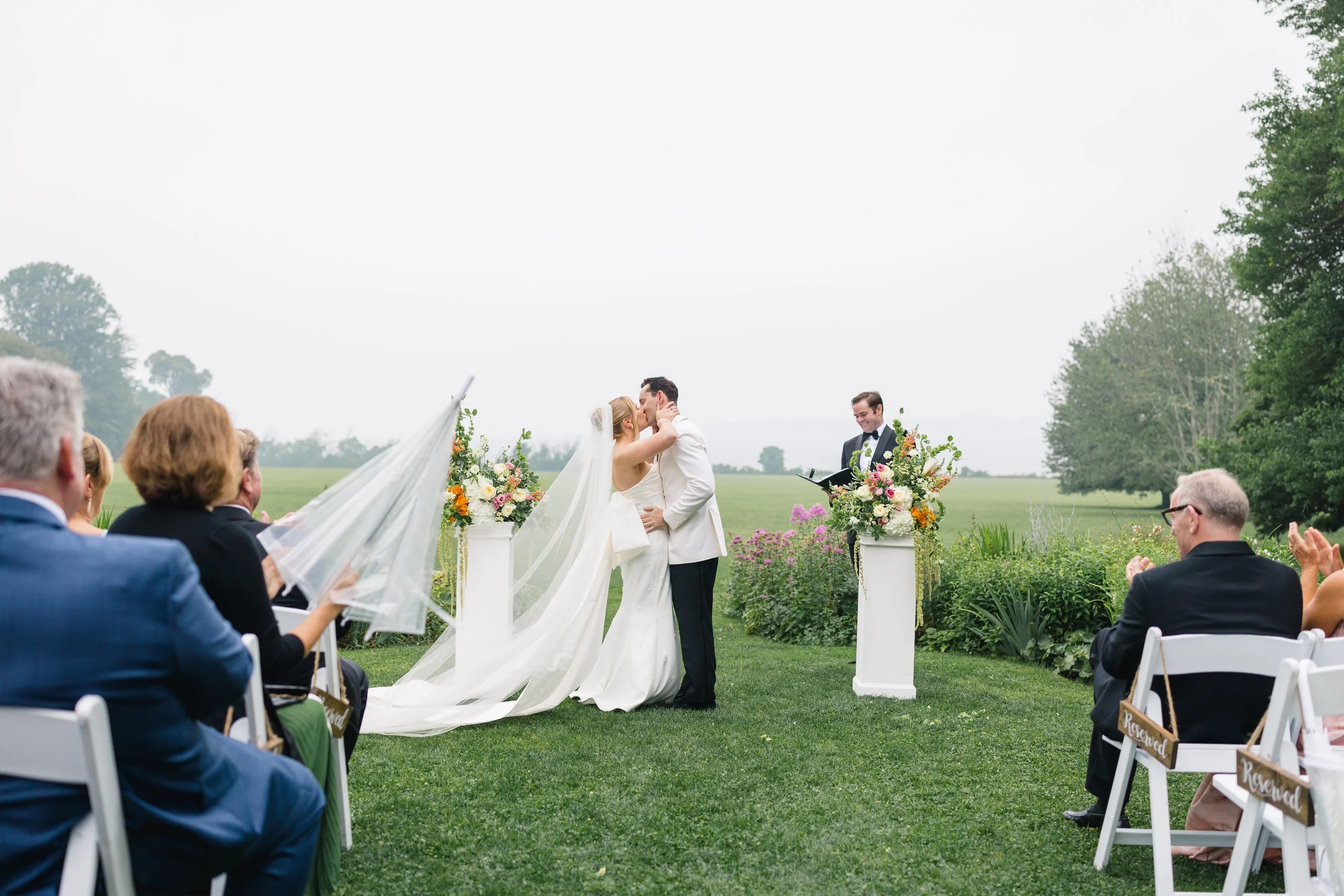 Guests celebrating a beautiful rainy ceremony at Blithewold Mansion & Gardens.