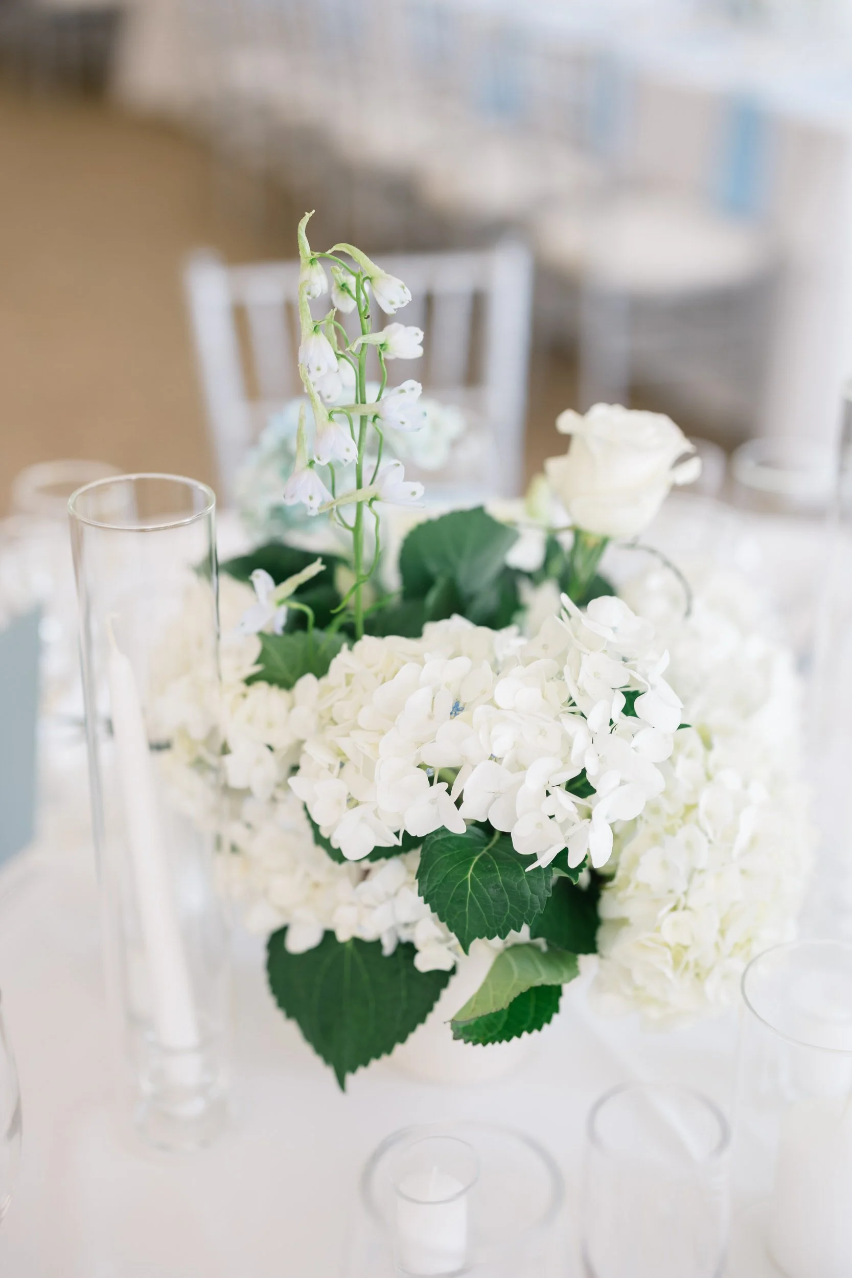 Coastal-inspired reception design featuring candlelight and garden party details.
