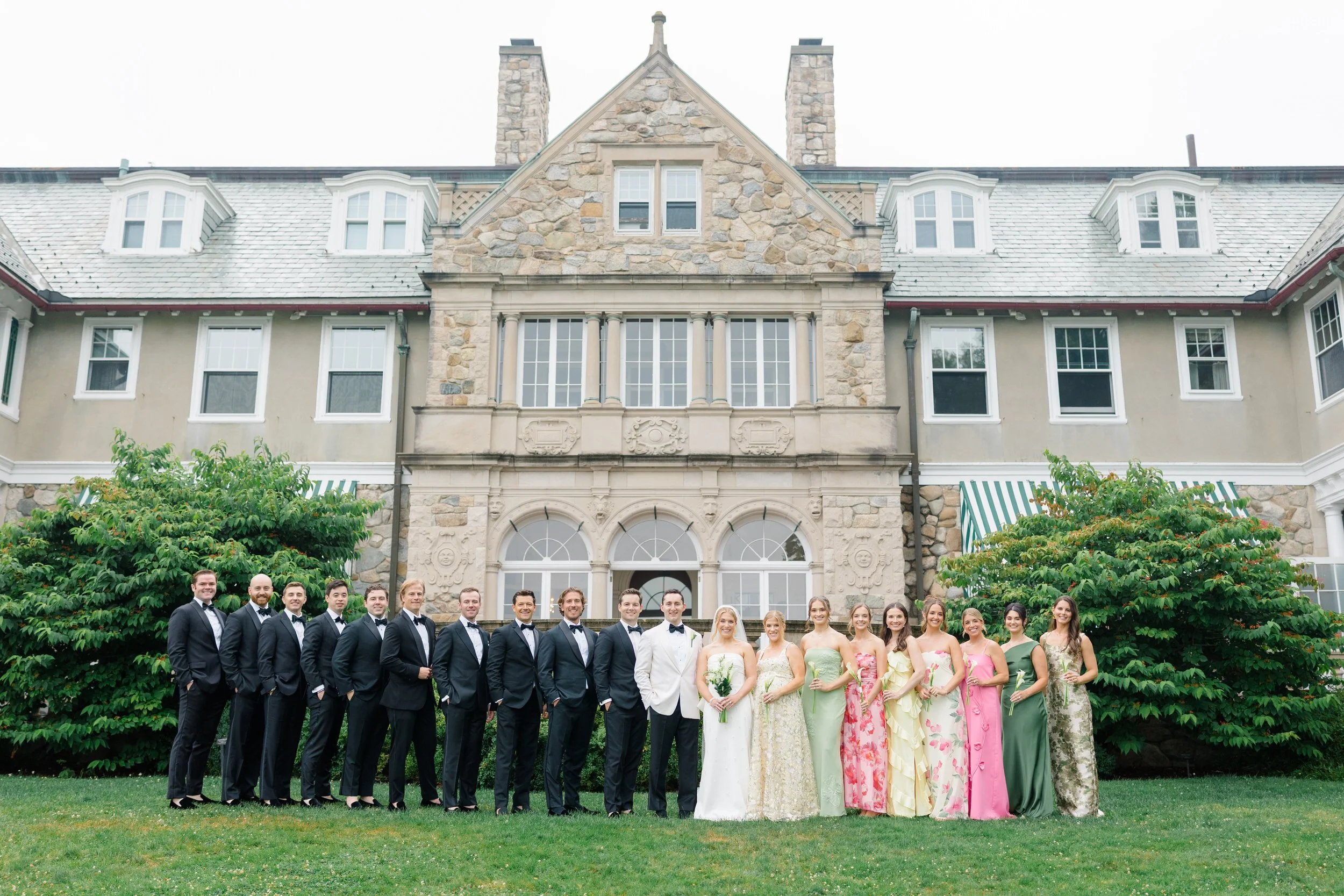Garden wedding party portraits featuring colorful spring-inspired attire.