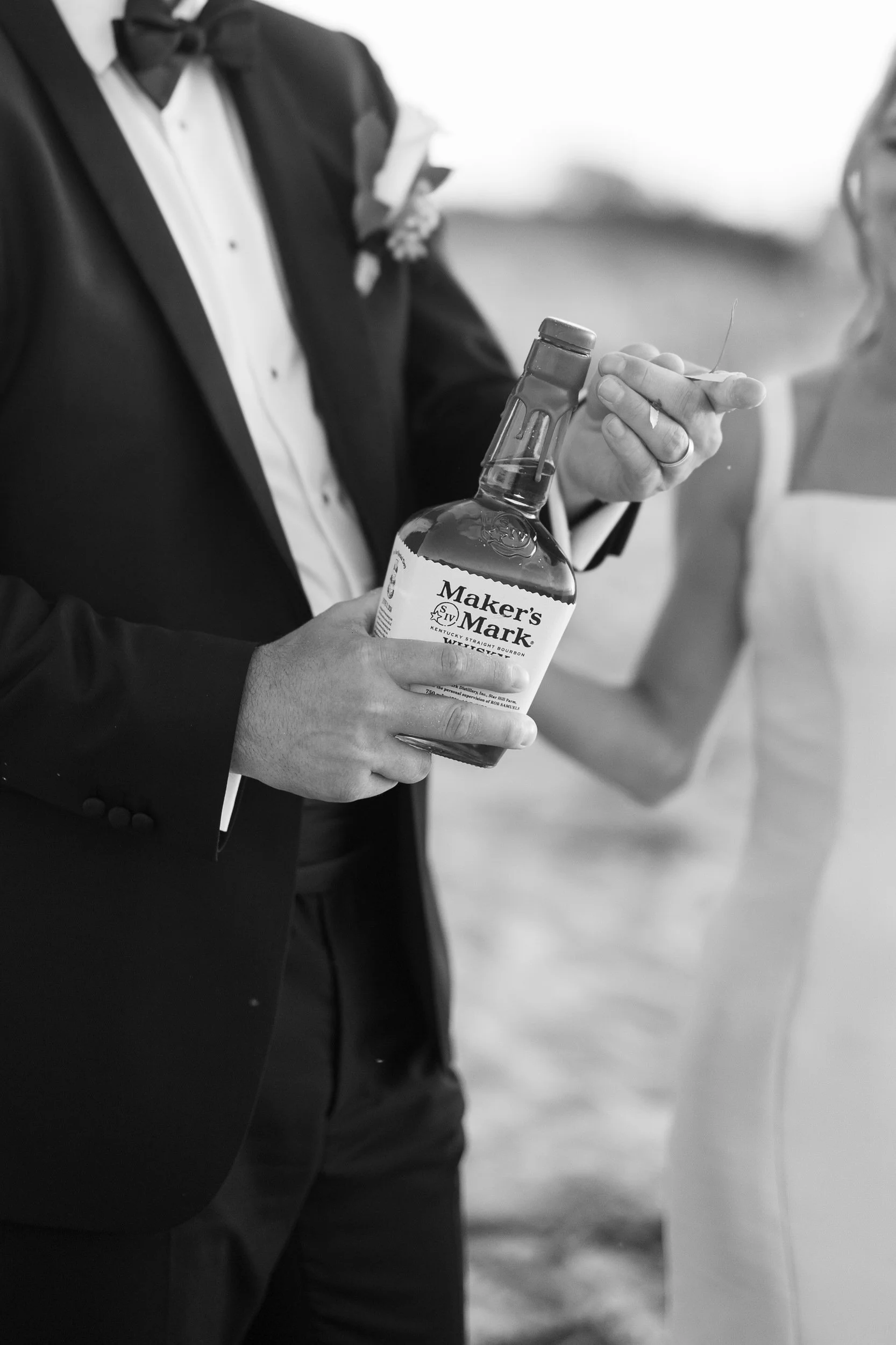 Newlyweds enjoying a whiskey toast during sunset portraits