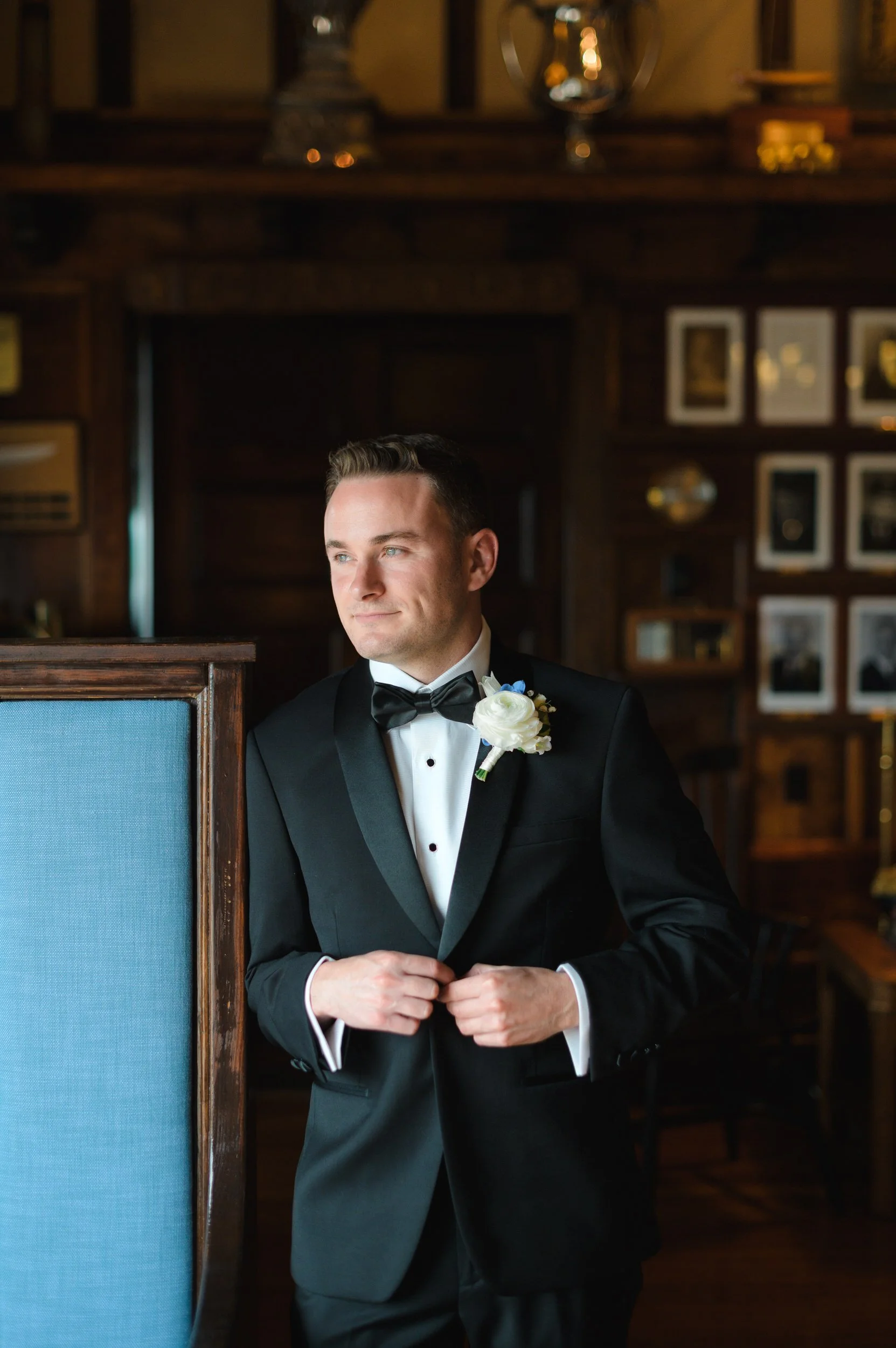 The groom gets ready for his Corinthian Yacht Club wedding surrounded by classic New England coastal charm.