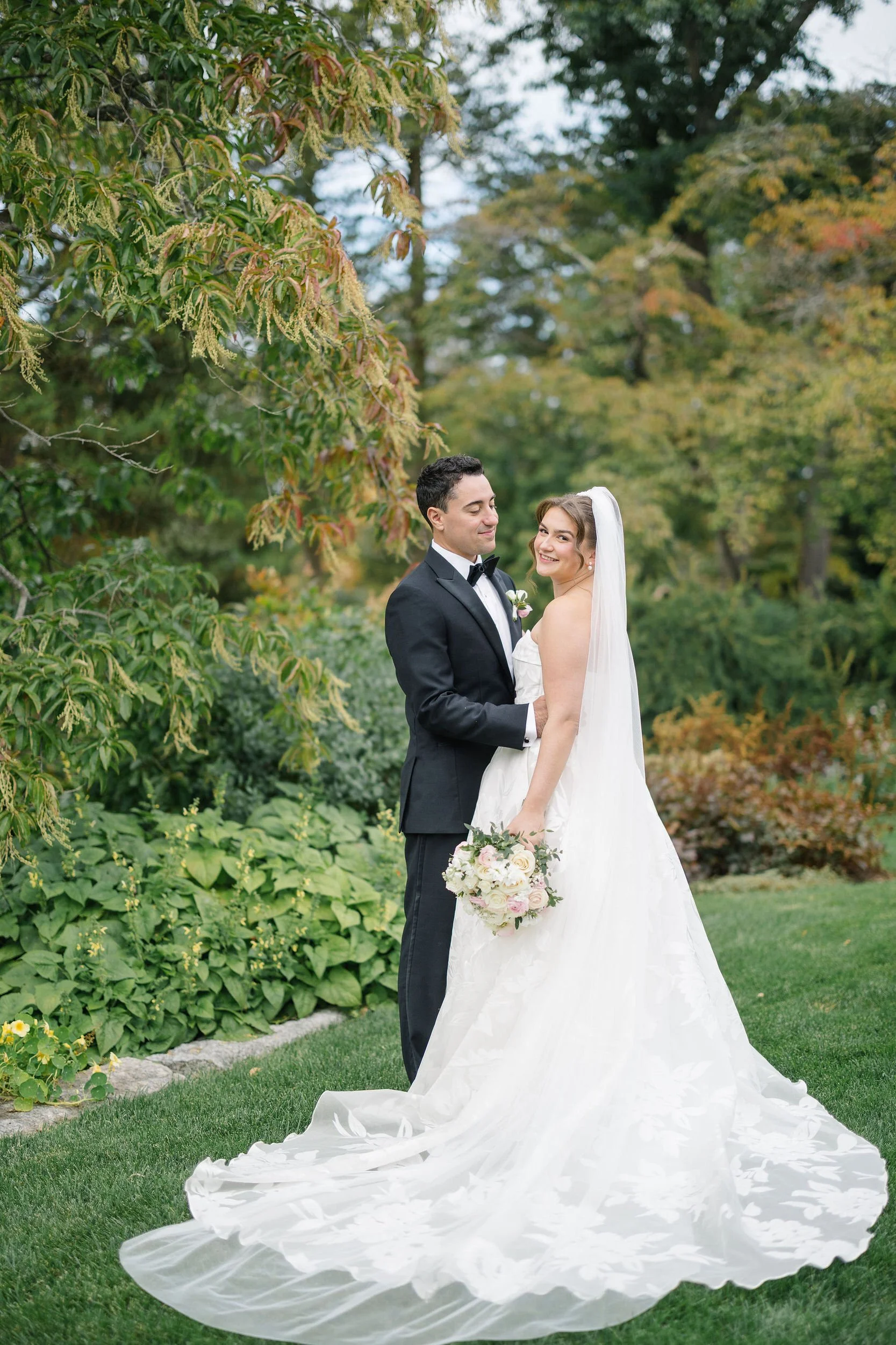 Romantic garden wedding portraits surrounded by greenery at Long Hill estate.
