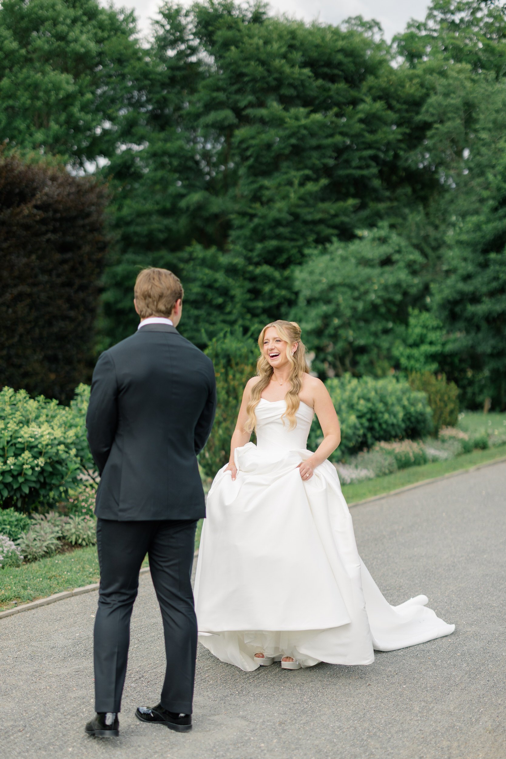 Couple’s first look surrounded by greenery at the Italian Gardens at Elm Bank