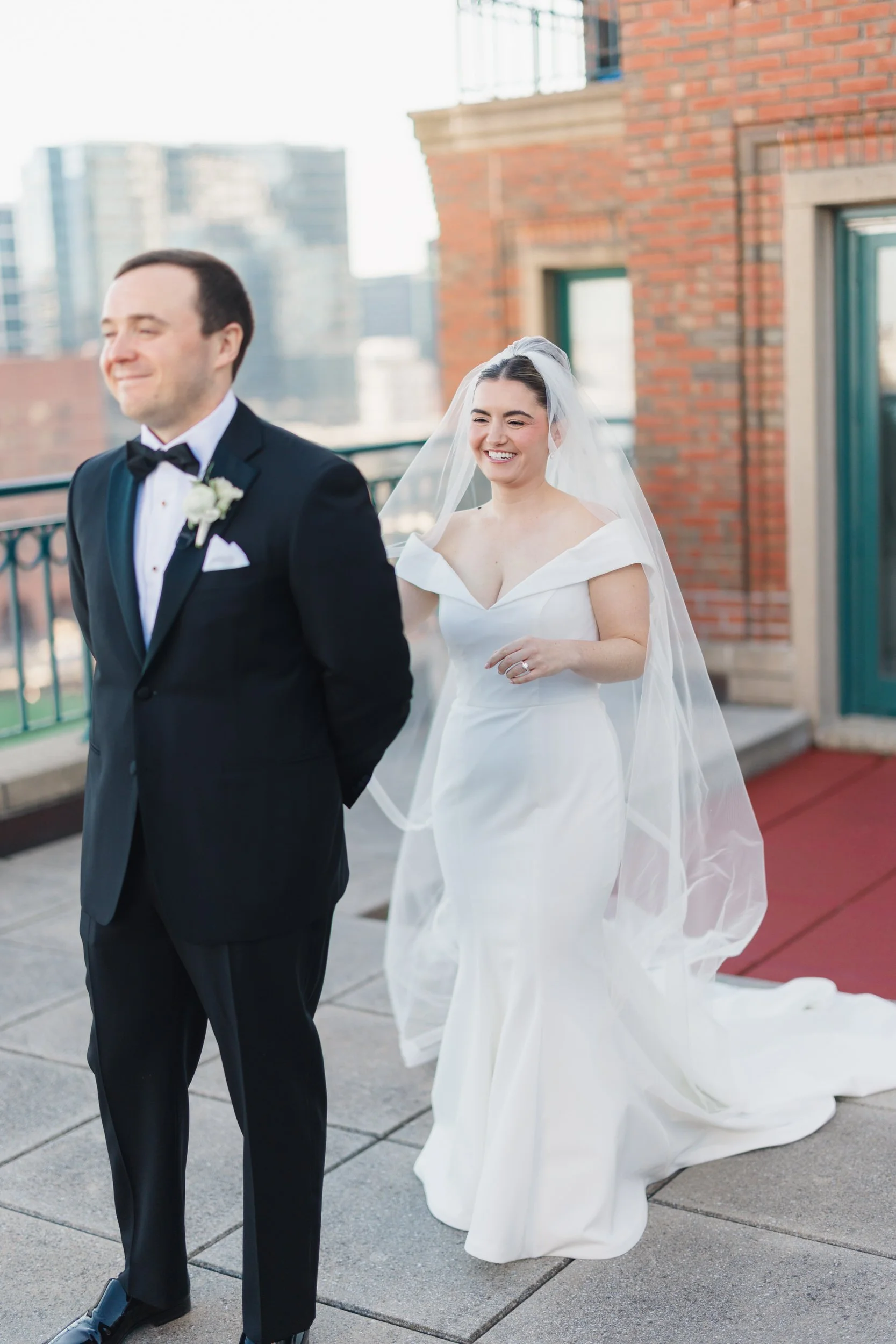 Emotional first look on the rooftop deck at a Boston Harbor Hotel wedding