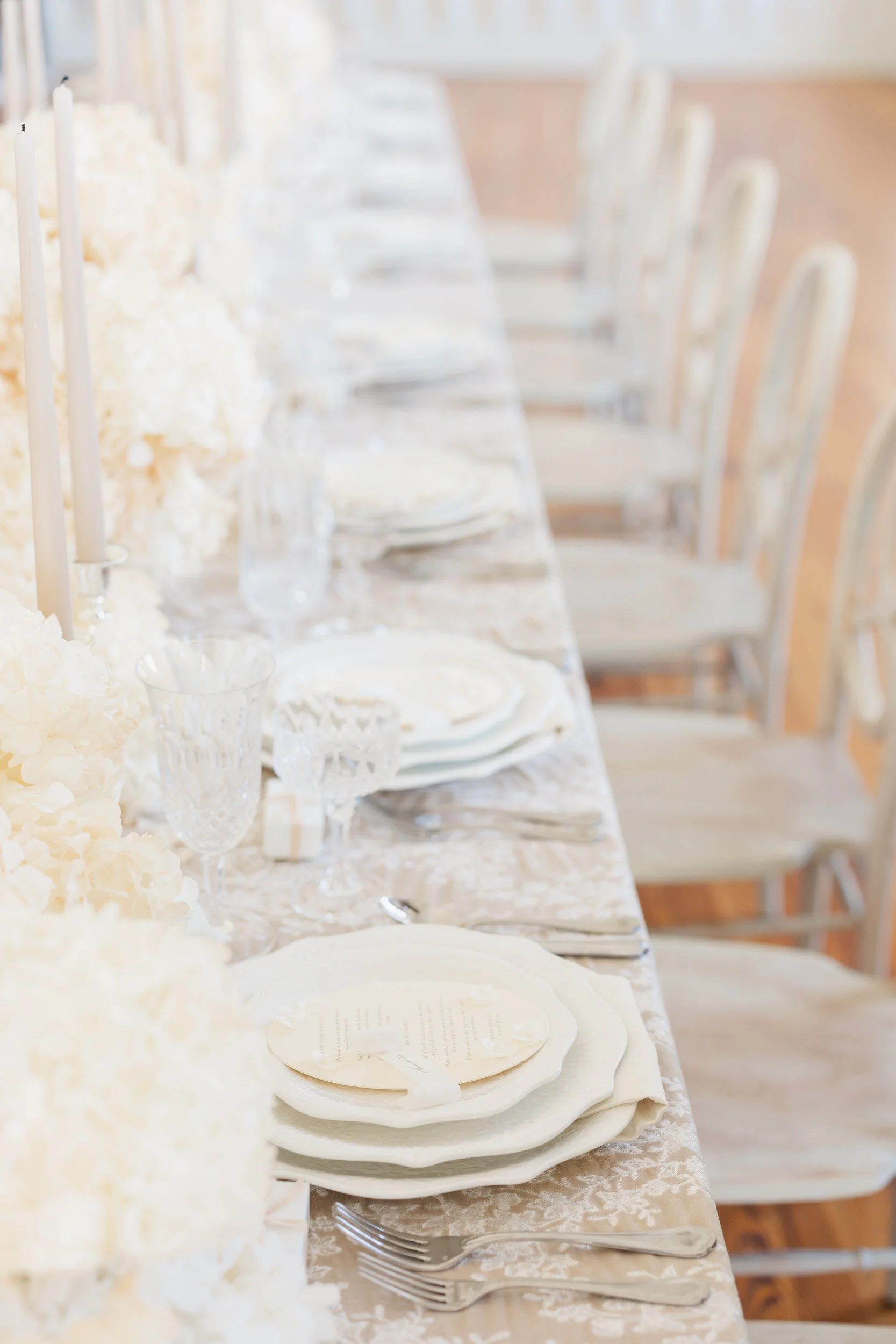 Chic neutral wedding design with candles and florals at Brasserie La Banque, Charleston, SC