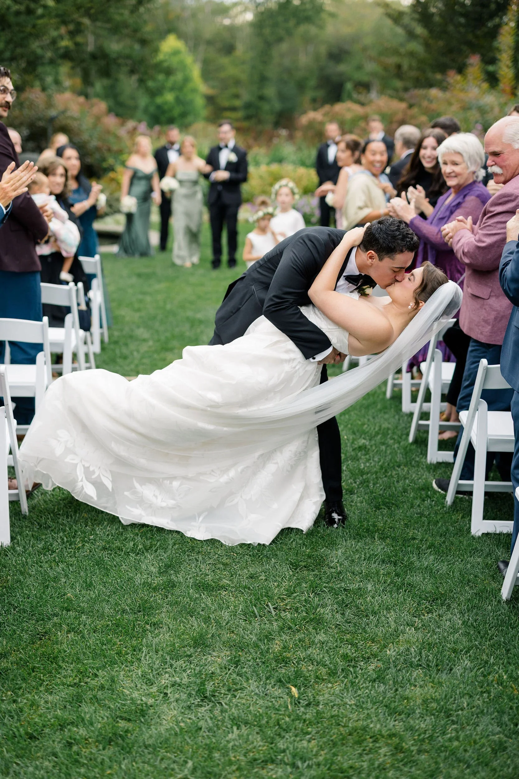 Couple sharing their first kiss as newlyweds at Long Hill.