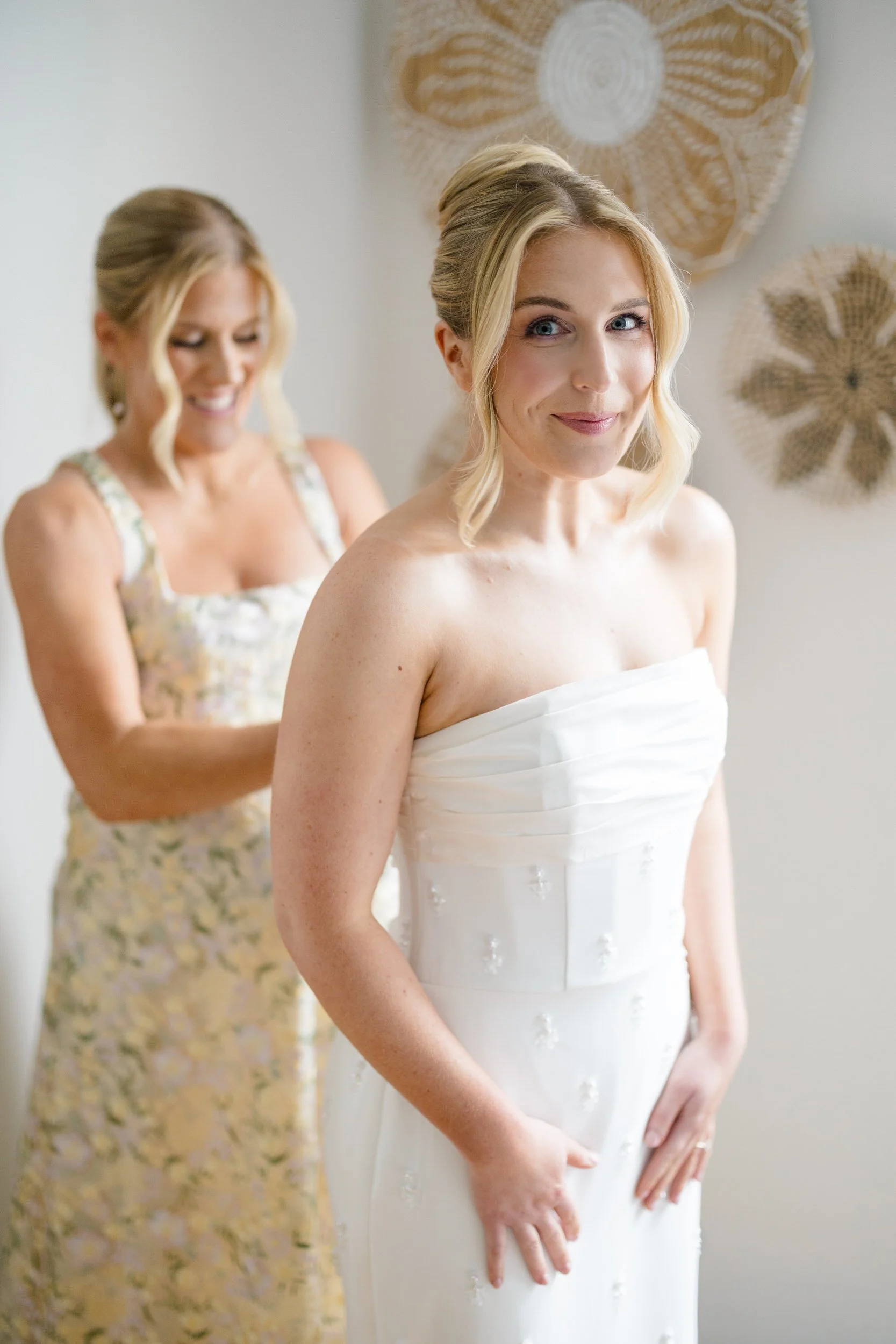 Bride adjusting her Watters wedding dress before portraits at Blithewold Mansion & Gardens.