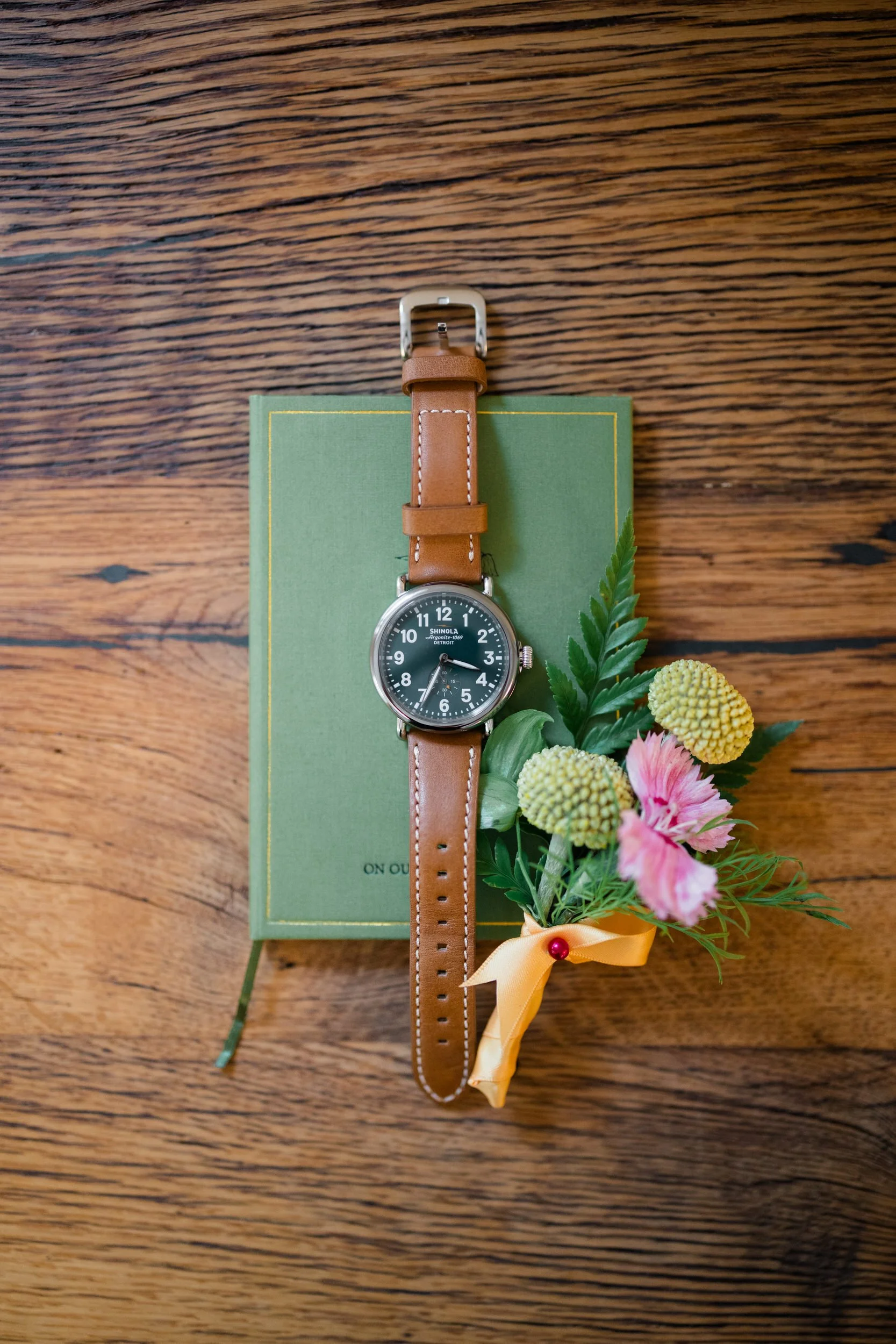 Colorful groom details styled alongside vibrant seasonal wedding florals at the Connors Center.