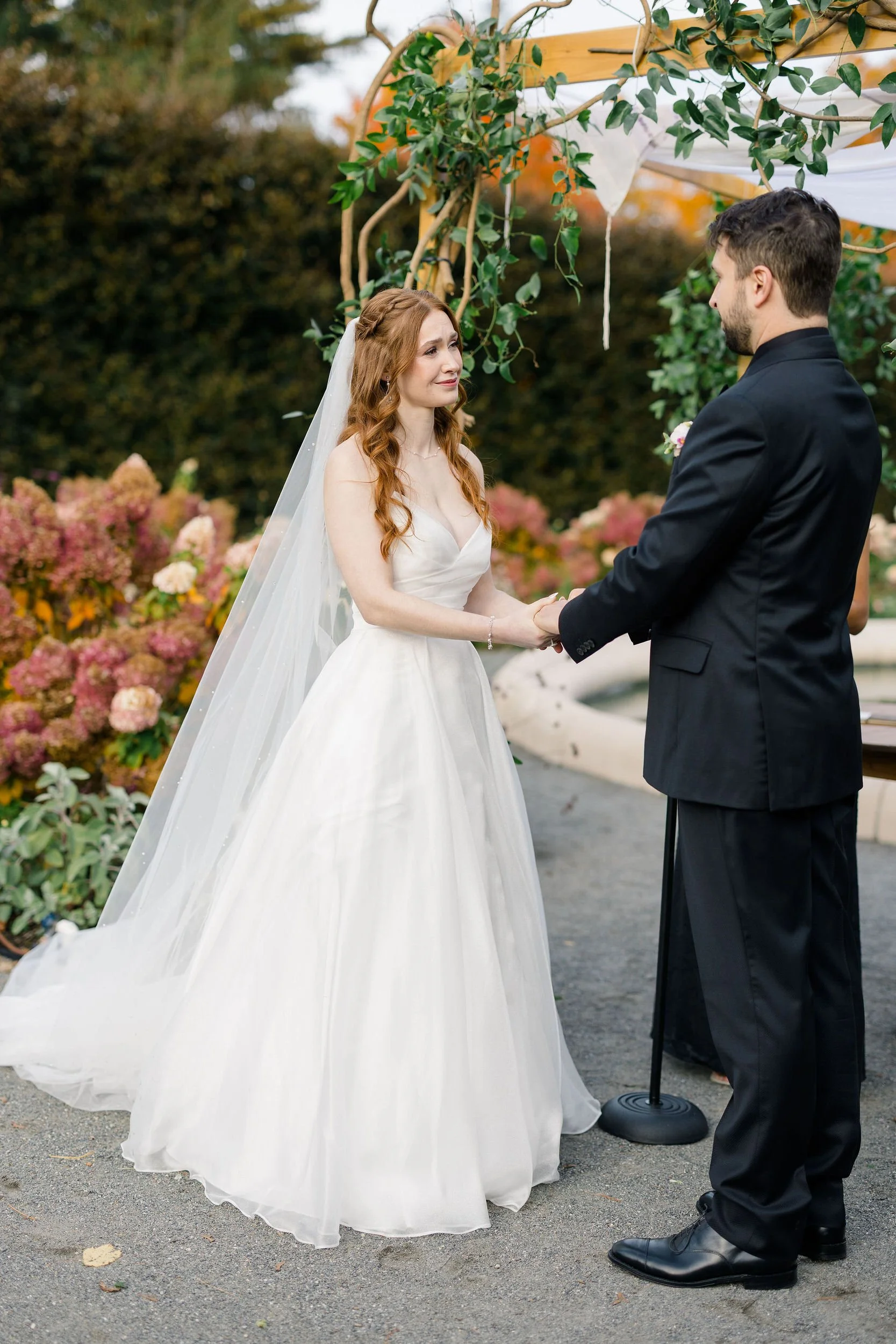 Romantic outdoor ceremony at a secret garden inspired wedding in Massachusetts.