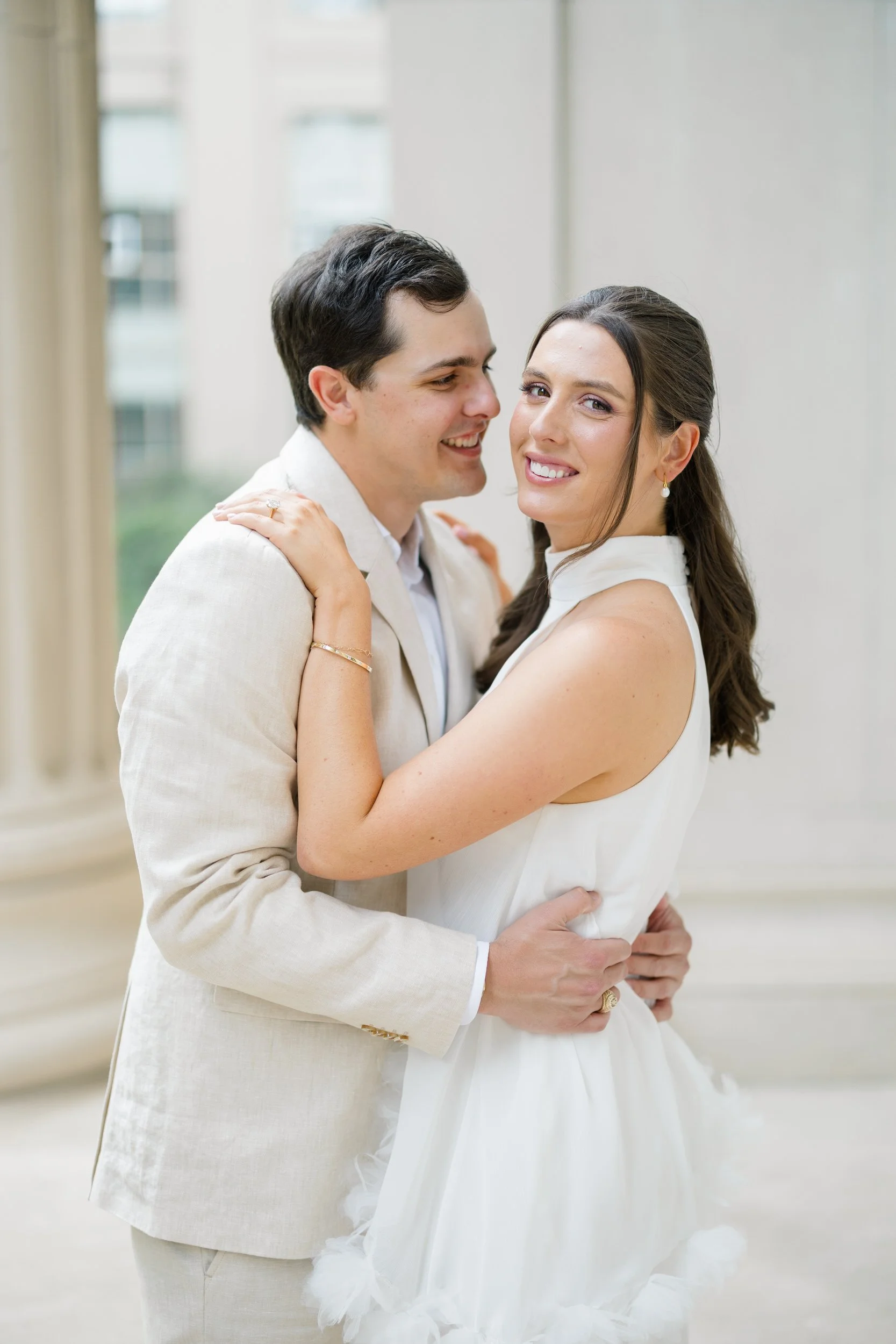 Timeless Cambridge engagement photos surrounded by marble columns and stone architecture.