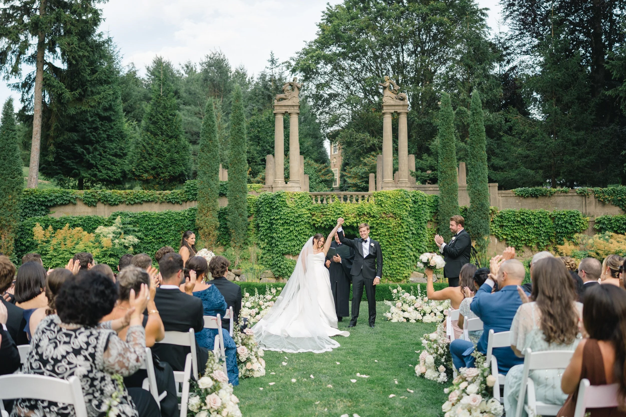 Bride and groom holding hands during their vows at one of Massachusetts’ most iconic wedding venues.