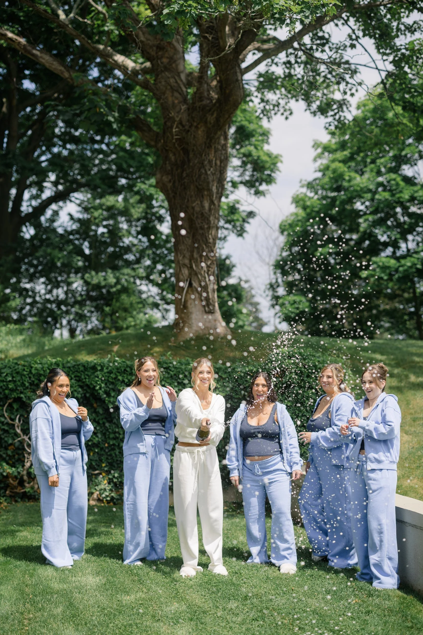 Bride sharing a joyful morning with her bridesmaids before the ceremony.